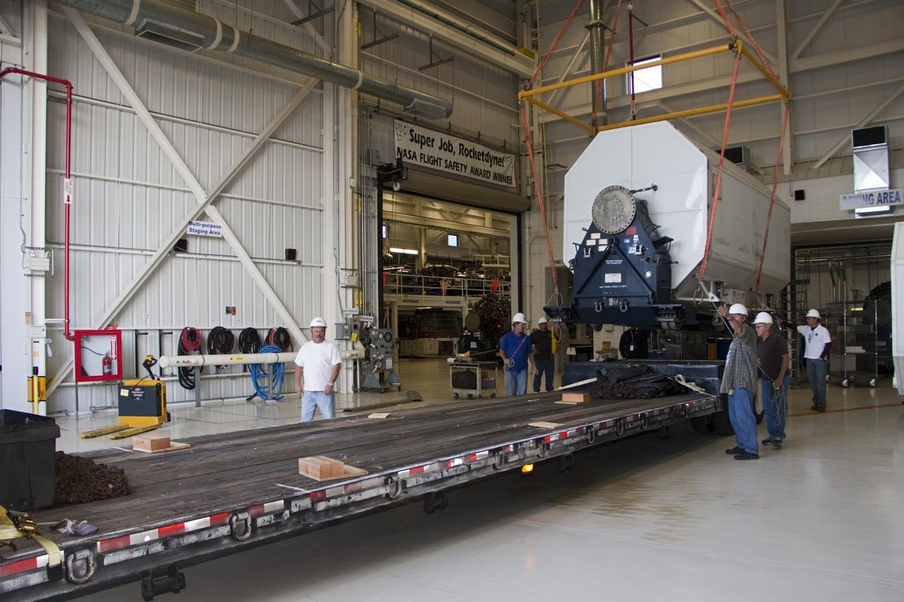 CAPE CANAVERAL, Fla. – In the Space Shuttle Main Engine Processing Facility at NASA’s Kennedy Space Center in Florida, a transportation canister containing a Pratt & Whitney Rocketdyne space shuttle main engine (SSME) is lifted into position onto a flatbed trailer. This is the second of the 15 engines used during the Space Shuttle Program to be transported to NASA's Stennis Space Center in Mississippi. The engines will be stored at Stennis for future use on NASA's new heavy-lift rocket, the Space Launch System (SLS), which will carry NASA's new Orion spacecraft, cargo, equipment and science experiments to space. For more information, visit http://www.nasa.gov/shuttle. Photo credit: NASA/Jim Grossmann