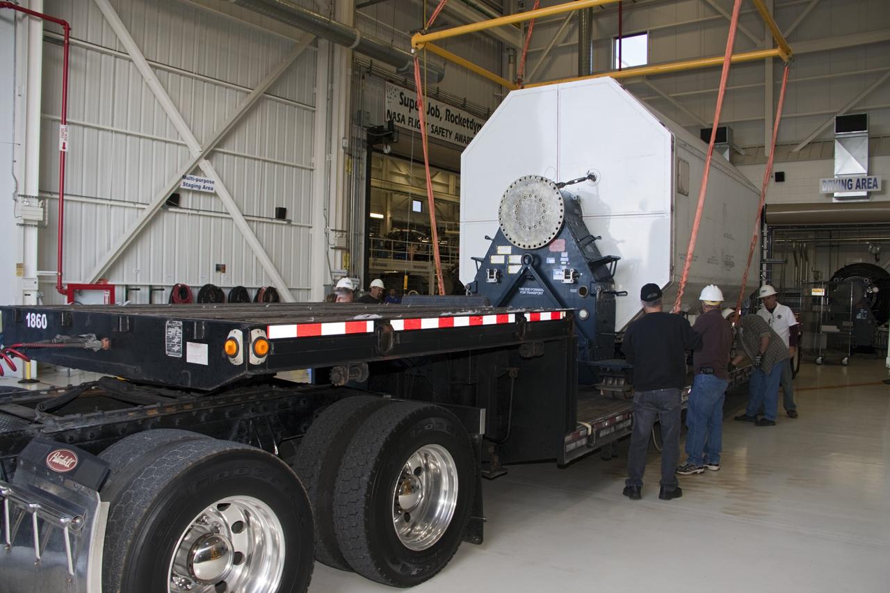 CAPE CANAVERAL, Fla. – In the Space Shuttle Main Engine Processing Facility at NASA’s Kennedy Space Center in Florida, a transportation canister containing a Pratt & Whitney Rocketdyne space shuttle main engine (SSME) is secured onto a flatbed trailer.    This is the second of the 15 engines used during the Space Shuttle Program to be transported to NASA's Stennis Space Center in Mississippi. The engines will be stored at Stennis for future use on NASA's new heavy-lift rocket, the Space Launch System (SLS), which will carry NASA's new Orion spacecraft, cargo, equipment and science experiments to space.  For more information, visit http://www.nasa.gov/shuttle.  Photo credit: NASA/Jim Grossmann
