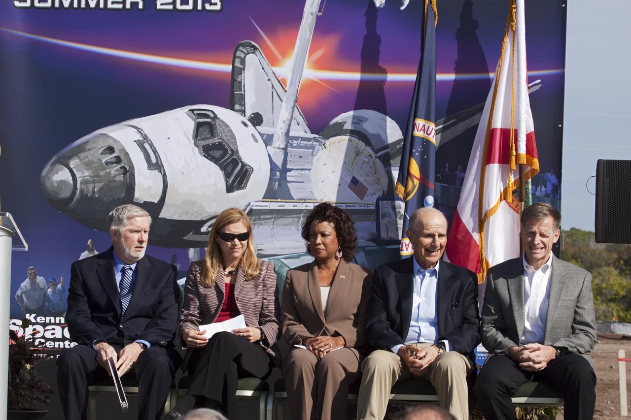 CAPE CANAVERAL, Fla. – In the Shuttle Plaza area at the Kennedy Space Center Visitor Complex (KSCVC) in Florida, dignitaries wait to speak during the Ground Breaking Ceremony for the future home of space shuttle Atlantis. From left, are KSCVC Chief Operating Officer Bill Moore; Kennedy Space Center Deputy Director Janet Petro; Lt. Governor of Florida Jennifer Carroll; Jeremy Jacobs, chairman and chief executive officer of Delaware North Companies; and STS-135 Commander Chris Ferguson.    Delaware North Parks & Resorts, in partnership with NASA’s Kennedy Space Center, broke ground for the 65,000 square-foot exhibit that will house Atlantis at the visitor complex. For more information, visit www.KennedySpaceCenter.com.  Photo credit: NASA/Jim Grossmann