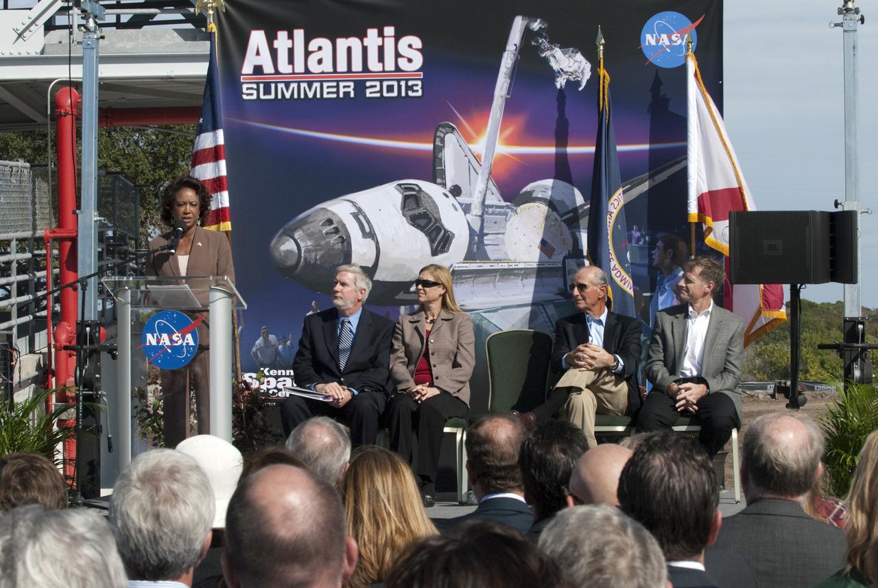 CAPE CANAVERAL, Fla. – In the Shuttle Plaza area at the Kennedy Space Center Visitor Complex (KSCVC) in Florida, Lt. Governor Jennifer Carroll speaks during the Ground Breaking Ceremony for the future home of space shuttle Atlantis. Seated at right, are KSCVC Chief Operating Officer Bill Moore; Kennedy Space Center Deputy Director Janet Petro; Jeremy Jacobs, chairman and chief executive officer of Delaware North Companies; and STS-135 Commander Chris Ferguson.      Delaware North Parks & Resorts, in partnership with NASA’s Kennedy Space Center, broke ground for the 65,000 square-foot exhibit that will house Atlantis at the visitor complex. For more information, visit www.KennedySpaceCenter.com.  Photo credit: NASA/Kim Shiflett
