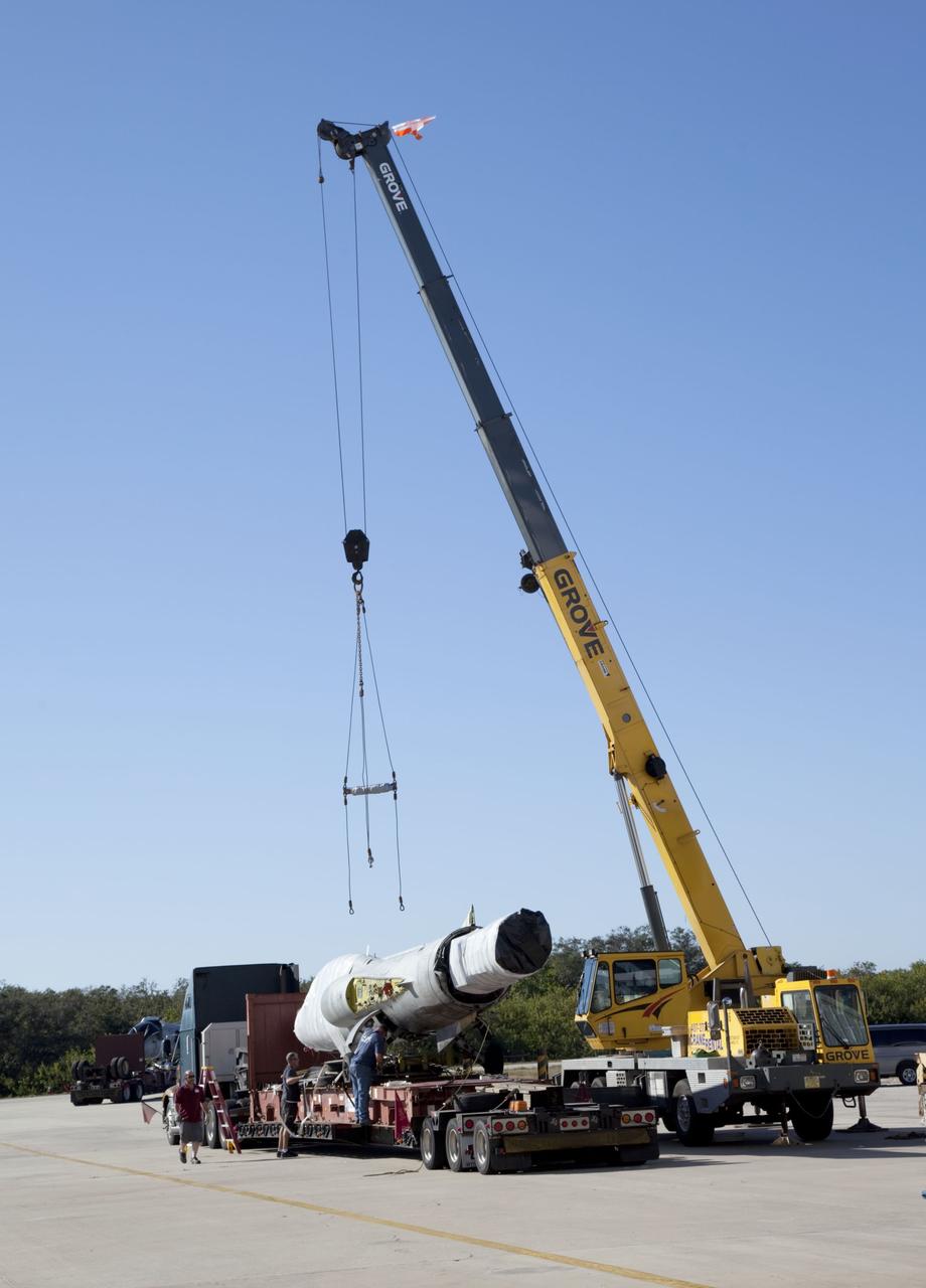 CAPE CANAVERAL, Fla. -- A crane lifts an F-104 Starfighter off the bed of a truck at NASA's Kennedy Space Center in Florida on Jan. 19, 2012. The aircraft is one of five delivered to the company recently. They will be reassembled to fly research and development and other missions. Starfighters operates out of a hangar at the Shuttle Landing Facility at Kennedy under an agreement with Kennedy. Photo credit: NASA/Frankie Martin