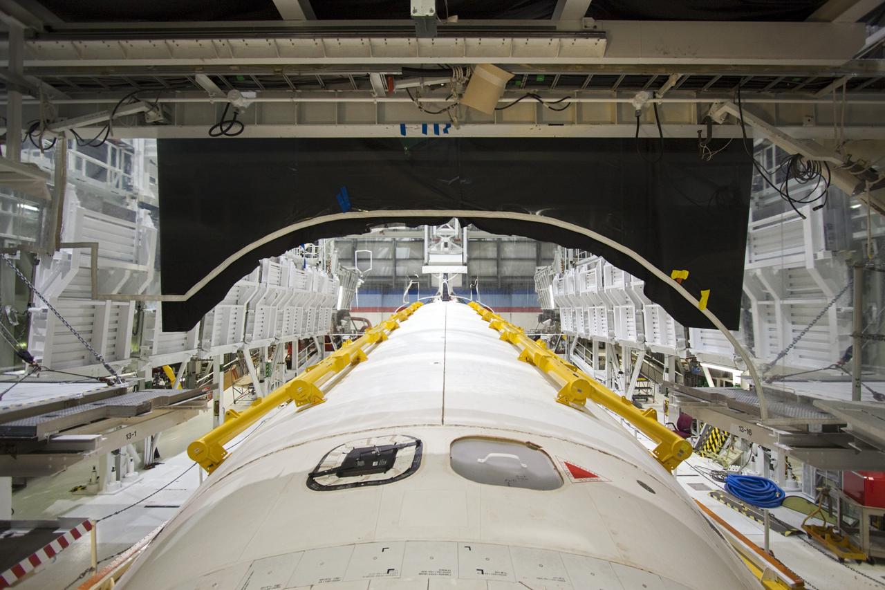 CAPE CANAVERAL, Fla. -- Strongbacks line the payload bay doors of space shuttle Atlantis for its move from Orbiter Processing Facility-2 to the Vehicle Assembly Building (VAB) at NASA's Kennedy Space Center in Florida. Atlantis will be stored temporarily in the VAB while transition and retirement processing resumes on shuttle Endeavour in the processing hangar. Endeavour is being prepared for public display at the California Science Center in Los Angeles. A groundbreaking was held Jan. 18 for Atlantis' future home -- a 65,000-square-foot exhibit in Shuttle Plaza at the Kennedy Space Center Visitor Complex. For additional information, visit http://www.nasa.gov/shuttle. Photo credit: NASA/Jim Grossmann