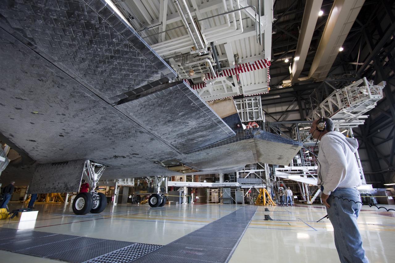 CAPE CANAVERAL, Fla. -- Slowly, carefully, space shuttle Atlantis backs away from the work platforms in Orbiter Processing Facility-2 on its move to the Vehicle Assembly Building (VAB) at NASA's Kennedy Space Center in Florida. Atlantis will be stored temporarily in the VAB while transition and retirement processing resumes on shuttle Endeavour in the processing hangar. Endeavour is being prepared for public display at the California Science Center in Los Angeles. A groundbreaking was held Jan. 18 for Atlantis' future home -- a 65,000-square-foot exhibit in Shuttle Plaza at the Kennedy Space Center Visitor Complex. For additional information, visit http://www.nasa.gov/shuttle. Photo credit: NASA/Jim Grossmann