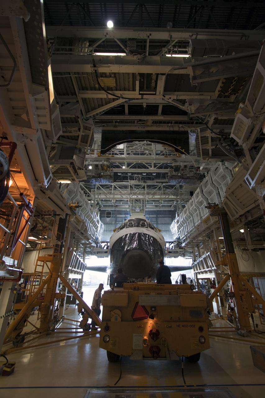 CAPE CANAVERAL, Fla. -- Space shuttle Atlantis is pushed away from the work platforms in Orbiter Processing Facility-2 on its move to the Vehicle Assembly Building (VAB) at NASA's Kennedy Space Center in Florida. Atlantis will be stored temporarily in the VAB while transition and retirement processing resumes on shuttle Endeavour in the processing hangar. Endeavour is being prepared for public display at the California Science Center in Los Angeles. A groundbreaking was held Jan. 18 for Atlantis' future home -- a 65,000-square-foot exhibit in Shuttle Plaza at the Kennedy Space Center Visitor Complex. For additional information, visit http://www.nasa.gov/shuttle. Photo credit: NASA/Jim Grossmann