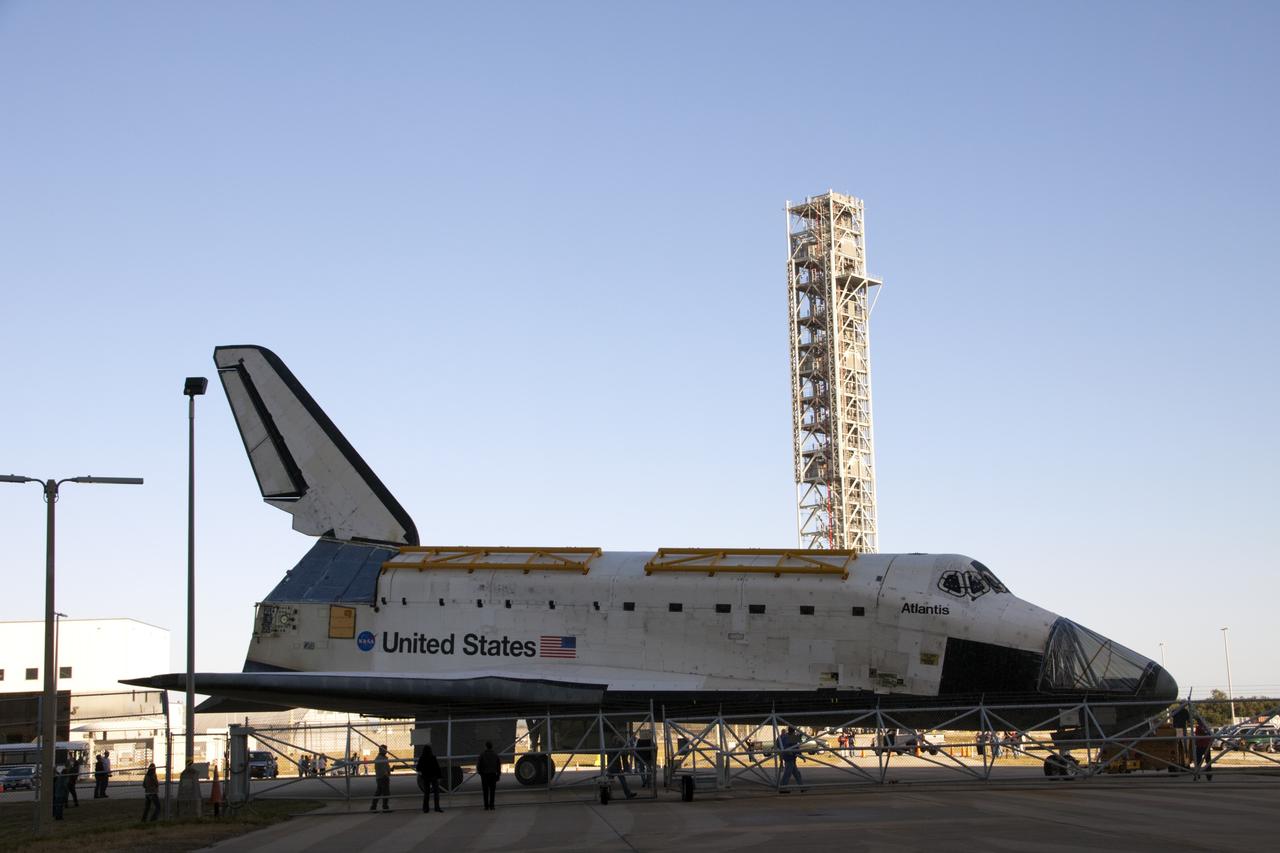 CAPE CANAVERAL, Fla. -- Space shuttle Atlantis rolls past NASA's new mobile launcher on its way from Orbiter Processing Facility-2 to the Vehicle Assembly Building (VAB) at NASA's Kennedy Space Center in Florida. Atlantis will be stored temporarily in the VAB while transition and retirement processing resumes on shuttle Endeavour in the processing hangar. Endeavour is being prepared for public display at the California Science Center in Los Angeles. A groundbreaking was held Jan. 18 for Atlantis' future home -- a 65,000-square-foot exhibit in Shuttle Plaza at the Kennedy Space Center Visitor Complex. For additional information, visit http://www.nasa.gov/shuttle. Photo credit: NASA/Jim Grossmann