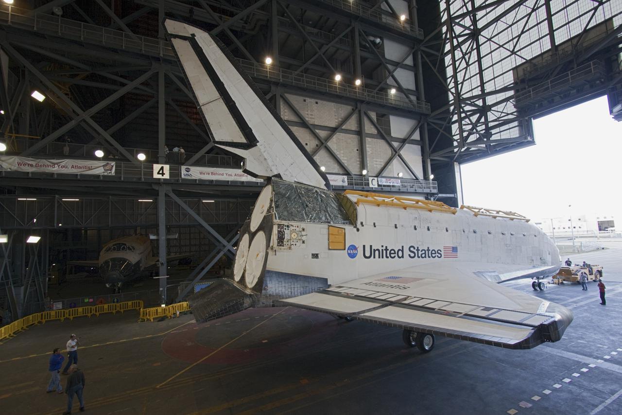 CAPE CANAVERAL, Fla. -- Space shuttle Atlantis backs into the transfer aisle of the Vehicle Assembly Building (VAB) at NASA's Kennedy Space Center in Florida on its move from Orbiter Processing Facility-2 . Atlantis will be stored temporarily in the VAB while transition and retirement processing resumes on shuttle Endeavour in the processing hangar. Endeavour is being prepared for public display at the California Science Center in Los Angeles. A groundbreaking was held Jan. 18 for Atlantis' future home -- a 65,000-square-foot exhibit in Shuttle Plaza at the Kennedy Space Center Visitor Complex. For additional information, visit http://www.nasa.gov/shuttle. Photo credit: NASA/Jim Grossmann