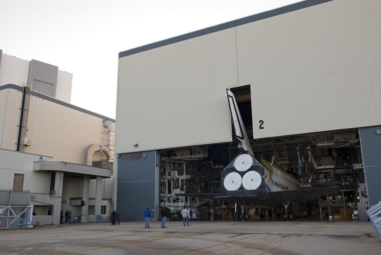 CAPE CANAVERAL, Fla. -- The tail fin of space shuttle Atlantis emerges through the open door of Orbiter Processing Facility-2 on its move to the Vehicle Assembly Building (VAB) at NASA's Kennedy Space Center in Florida. Atlantis will be stored temporarily in the VAB while transition and retirement processing resumes on shuttle Endeavour in the processing hangar. Endeavour is being prepared for public display at the California Science Center in Los Angeles. A groundbreaking was held Jan. 18 for Atlantis' future home -- a 65,000-square-foot exhibit in Shuttle Plaza at the Kennedy Space Center Visitor Complex. For additional information, visit http://www.nasa.gov/shuttle. Photo credit: NASA/Charisse Nahser