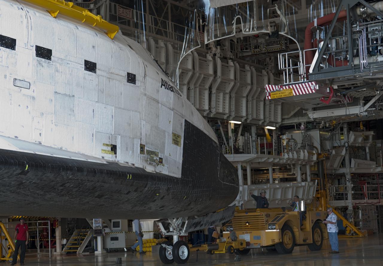 CAPE CANAVERAL, Fla. -- Workers push space shuttle Atlantis away from the work platforms in Orbiter Processing Facility-2 for its move to the Vehicle Assembly Building (VAB) at NASA's Kennedy Space Center in Florida. Atlantis will be stored temporarily in the VAB while transition and retirement processing resumes on shuttle Endeavour in the processing hangar. Endeavour is being prepared for public display at the California Science Center in Los Angeles. A groundbreaking was held Jan. 18 for Atlantis' future home -- a 65,000-square-foot exhibit in Shuttle Plaza at the Kennedy Space Center Visitor Complex. For additional information, visit http://www.nasa.gov/shuttle. Photo credit: NASA/Charisse Nahser