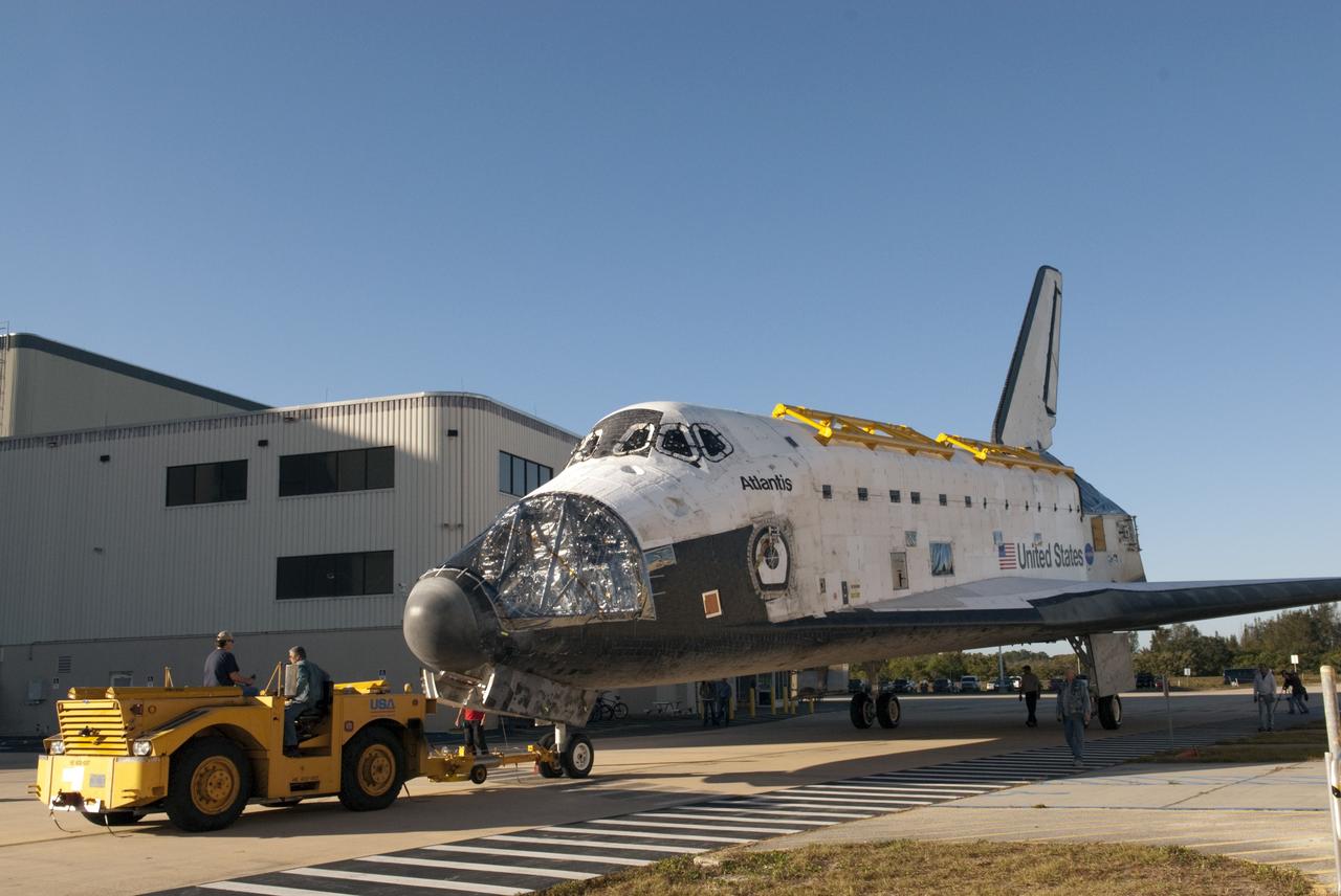 CAPE CANAVERAL, Fla. -- Slowly, carefully, space shuttle Atlantis is pulled from Orbiter Processing Facility-2 to the Vehicle Assembly Building (VAB) at NASA's Kennedy Space Center in Florida. Atlantis will be stored temporarily in the VAB while transition and retirement processing resumes on shuttle Endeavour in the processing hangar. Endeavour is being prepared for public display at the California Science Center in Los Angeles. A groundbreaking was held Jan. 18 for Atlantis' future home -- a 65,000-square-foot exhibit in Shuttle Plaza at the Kennedy Space Center Visitor Complex. For additional information, visit http://www.nasa.gov/shuttle. Photo credit: NASA/Charisse Nahser