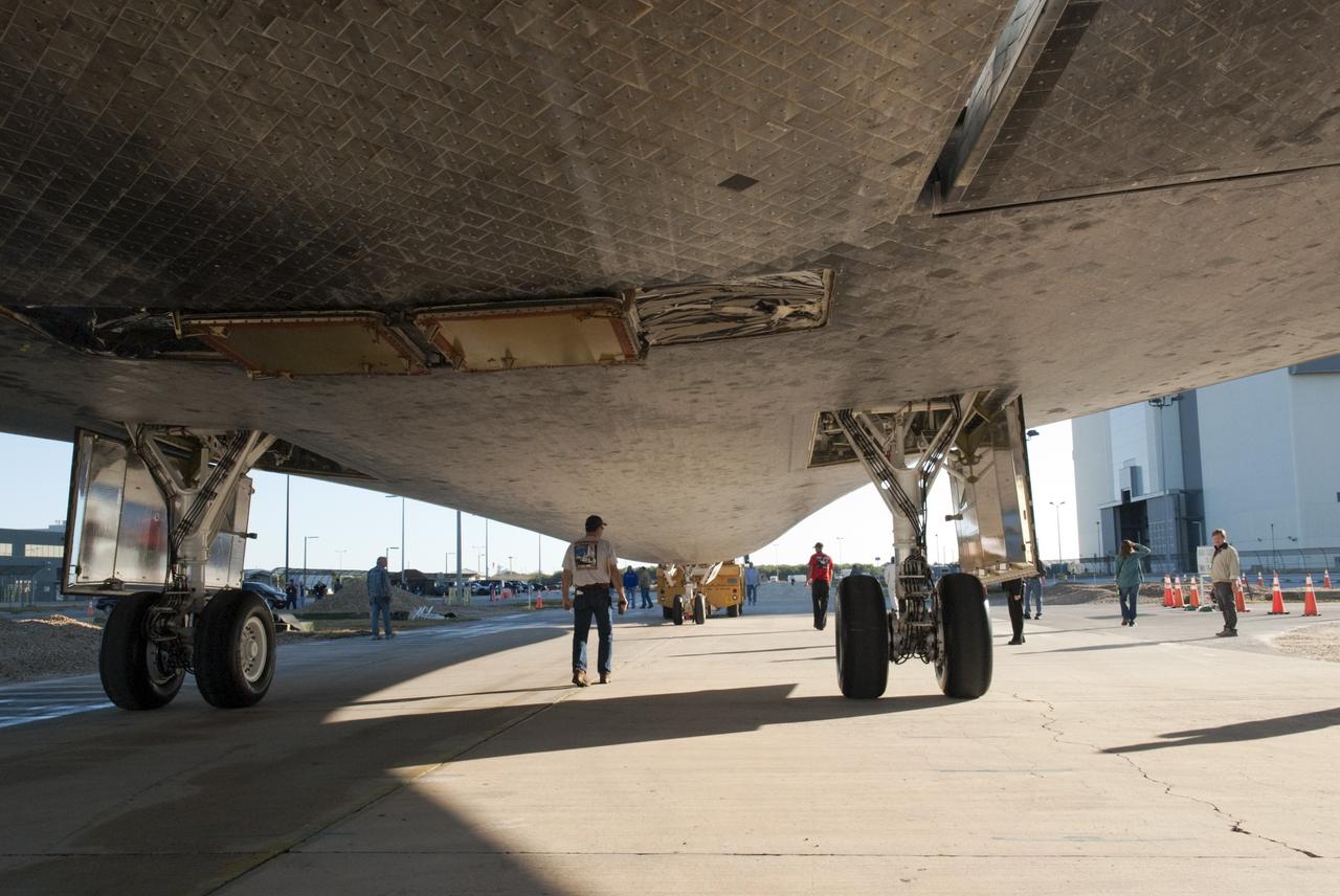 CAPE CANAVERAL, Fla. -- A shuttle monitor is in position underneath space shuttle Atlantis as it is pulled from Orbiter Processing Facility-2 to the Vehicle Assembly Building (VAB) at NASA's Kennedy Space Center in Florida. Atlantis will be stored temporarily in the VAB while transition and retirement processing resumes on shuttle Endeavour in the processing hangar. Endeavour is being prepared for public display at the California Science Center in Los Angeles. A groundbreaking was held Jan. 18 for Atlantis' future home -- a 65,000-square-foot exhibit in Shuttle Plaza at the Kennedy Space Center Visitor Complex. For additional information, visit http://www.nasa.gov/shuttle. Photo credit: NASA/Charisse Nahser