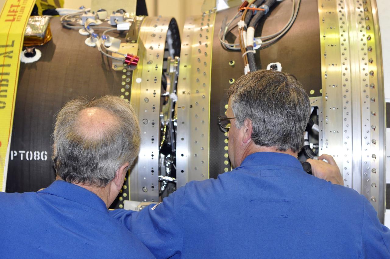 VANDENBERG AIR FORCE BASE, Calif. -- Orbital Sciences Corp. engineers oversee the remating of stages 2 and 3 of the Pegasus rocket in processing facility 1555 at Vandenberg Air Force Base (VAFB) in California. The stages were remated after some RF electrical cabling was reinstalled. The rocket is being prepared to launch NASA's Nuclear Spectroscopic Telescope Array (NuSTAR) into space. After the rocket and spacecraft are processed at Vandenberg, they will be flown on the Orbital Sciences' L-1011 carrier aircraft to the Ronald Reagan Ballistic Missile Defense Test Site at the Pacific Ocean's Kwajalein Atoll for launch, targeted for no earlier than March 14. The high-energy x-ray telescope will conduct a census for black holes, map radioactive material in young supernovae remnants, and study the origins of cosmic rays and the extreme physics around collapsed stars. For more information, visit http://www.nasa.gov/nustar. Photo credit: NASA/Randy Beaudoin, VAFB