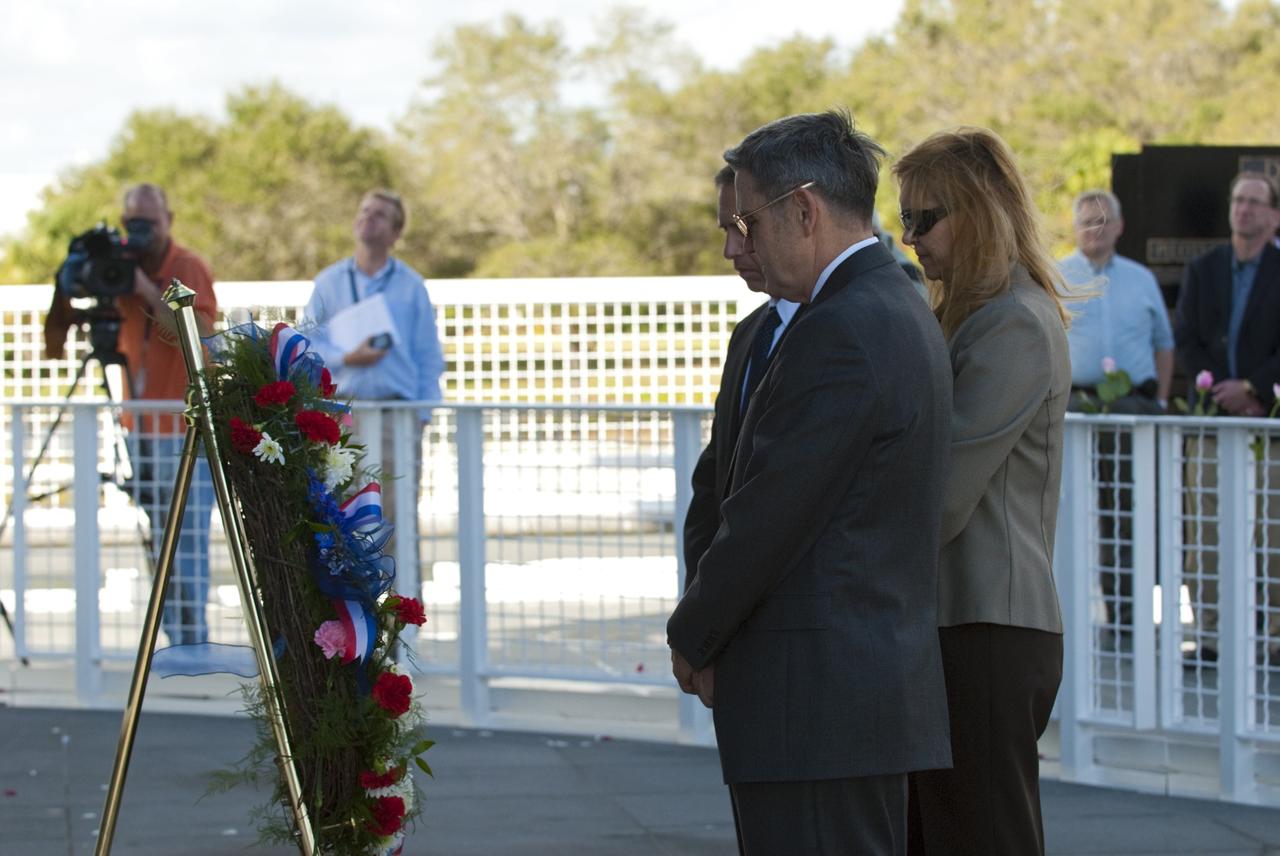 CAPE CANAVERAL, Fla. -- Kennedy Space Center Director Robert Cabana, Deputy Director Janet Petro, and United Space Alliance’s Vice President for Aerospace Services/Florida Site Director Mark Nappi place a wreath at the Space Mirror Memorial at the Kennedy Space Center Visitor Complex in Florida during Kennedy’s NASA Day of Remembrance. The Day of Remembrance honors members of the NASA family who lost their lives while furthering the cause of exploration and discovery, including the astronaut crews of Apollo 1 and space shuttles Challenger and Columbia. Kennedy civil service and contractor employees, along with the general public, paid their respects throughout the day. The visitor complex provided flowers for visitors to place at the memorial. Photo credit: NASA/Kim Shiflett