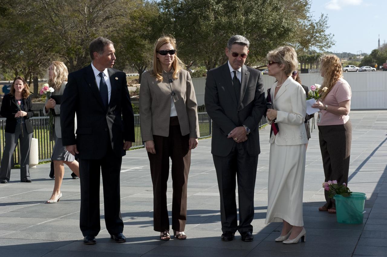 CAPE CANAVERAL, Fla. -- During Kennedy Space Center’s NASA Day of Remembrance at the Space Mirror Memorial at the Kennedy Space Center Visitor Complex in Florida, United Space Alliance’s Vice President for Aerospace Services/Florida Site Director Mark Nappi, at left, Kennedy Deputy Director Janet Petro, and Kennedy Center Director Robert Cabana prepare to place a wreath at the memorial. The Day of Remembrance honors members of the NASA family who lost their lives while furthering the cause of exploration and discovery, including the astronaut crews of Apollo 1 and space shuttles Challenger and Columbia. Kennedy civil service and contractor employees, along with the general public, paid their respects throughout the day. The visitor complex provided flowers for visitors to place at the memorial. Photo credit: NASA/Kim Shiflett