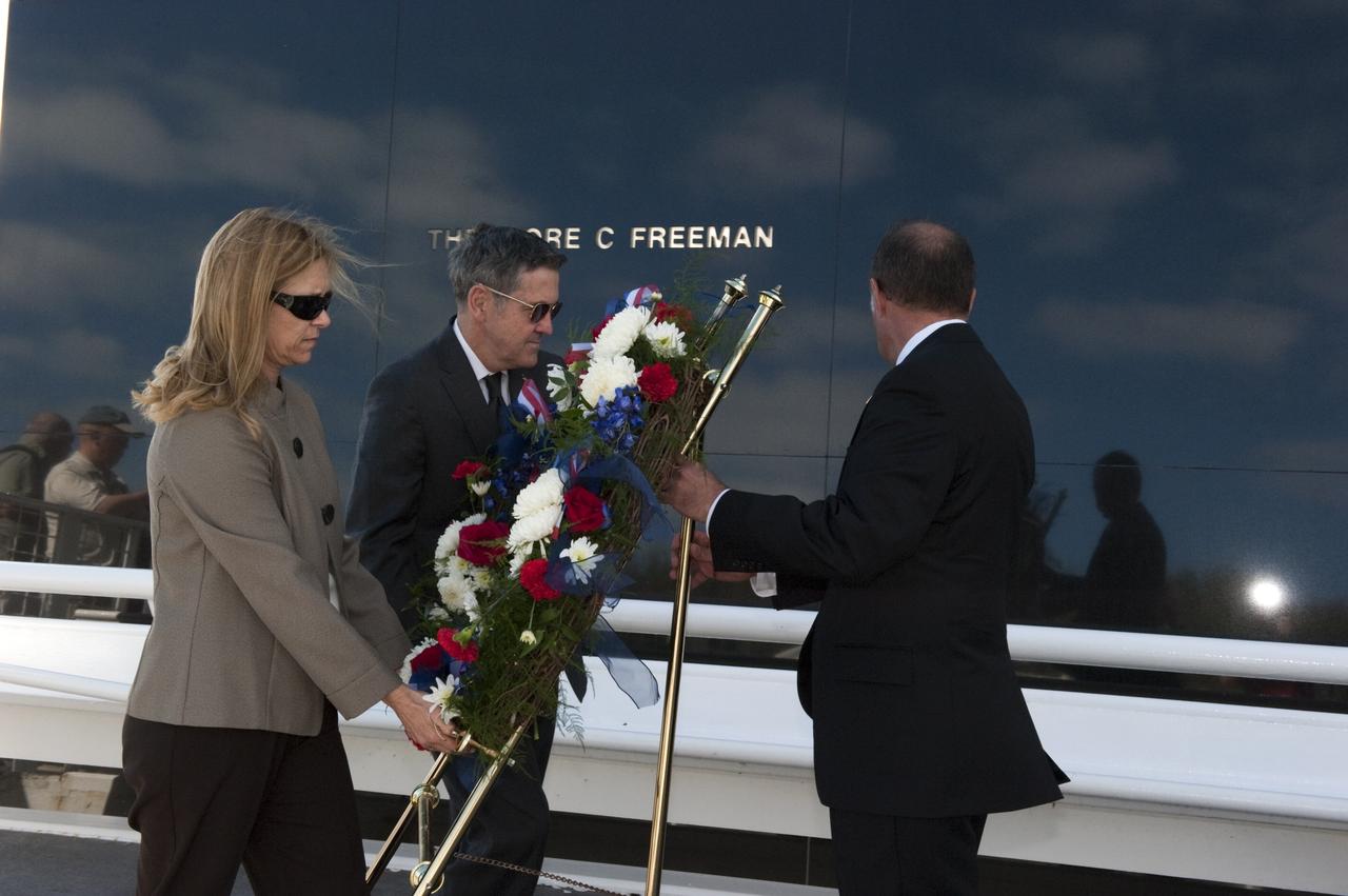 CAPE CANAVERAL, Fla. -- Kennedy Space Center Deputy Director Janet Petro, at left, Kennedy Center Director Robert Cabana, and United Space Alliance’s Vice President for Aerospace Services/Florida Site Director Mark Nappi, place a wreath at the Space Mirror Memorial at the Kennedy Space Center Visitor Complex during Kennedy’s NASA Day of Remembrance. The Day of Remembrance honors members of the NASA family who lost their lives while furthering the cause of exploration and discovery, including the astronaut crews of Apollo 1 and space shuttles Challenger and Columbia. Kennedy civil service and contractor employees, along with the general public, paid their respects throughout the day. The visitor complex provided flowers for visitors to place at the memorial. Photo credit: NASA/Kim Shiflett