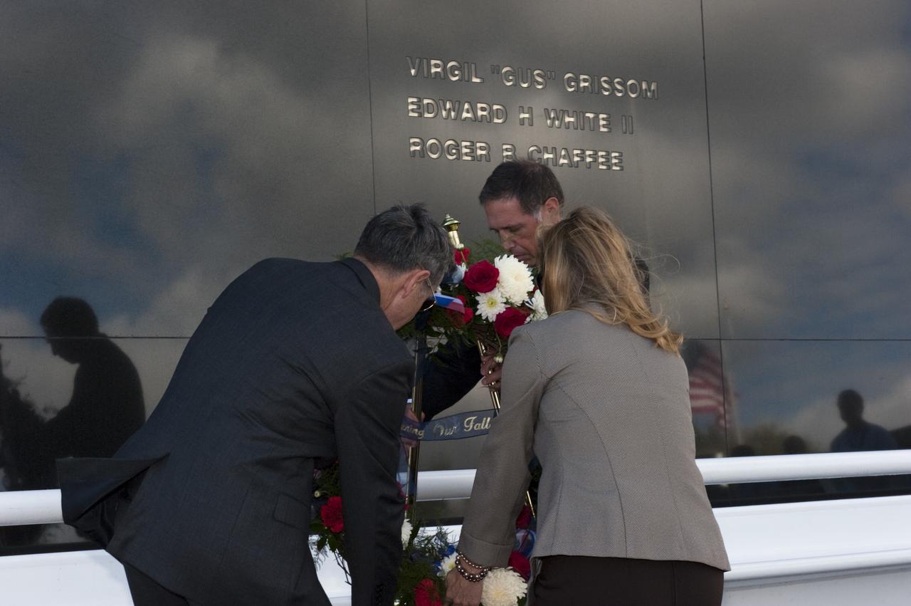 CAPE CANAVERAL, Fla. -- Kennedy Space Center Director Robert Cabana, at left, Deputy Director Janet Petro, and United Space Alliance’s Vice President for Aerospace Services/Florida Site Director Mark Nappi, place a wreath at the Space Mirror Memorial at the Kennedy Space Center Visitor Complex in Florida during Kennedy’s NASA Day of Remembrance. The Day of Remembrance honors members of the NASA family who lost their lives while furthering the cause of exploration and discovery, including the astronaut crews of Apollo 1 and space shuttles Challenger and Columbia. Kennedy civil service and contractor employees, along with the general public, paid their respects throughout the day. The visitor complex provided flowers for visitors to place at the memorial. Photo credit: NASA/Kim Shiflett