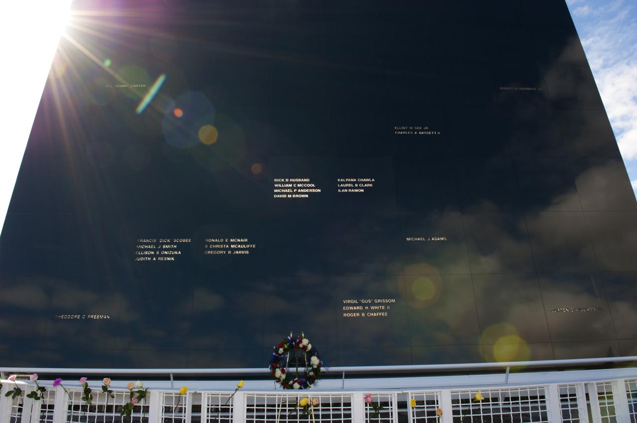 CAPE CANAVERAL, Fla. -- The Space Mirror Memorial at the Kennedy Space Center Visitor Complex in Florida gleams in the morning sunlight during Kennedy’s NASA Day of Remembrance. A large wreath was placed at the memorial by Kennedy Center Director Robert Cabana, Deputy Director Janet Petro, and United Space Alliance’s Vice President for Aerospace Services/Florida Site Director Mark Nappi. The Day of Remembrance honors members of the NASA family who lost their lives while furthering the cause of exploration and discovery, including the astronaut crews of Apollo 1 and space shuttles Challenger and Columbia. Kennedy civil service and contractor employees, along with the general public, paid their respects throughout the day. The visitor complex provided flowers for visitors to place at the memorial. Photo credit: NASA/Kim Shiflett