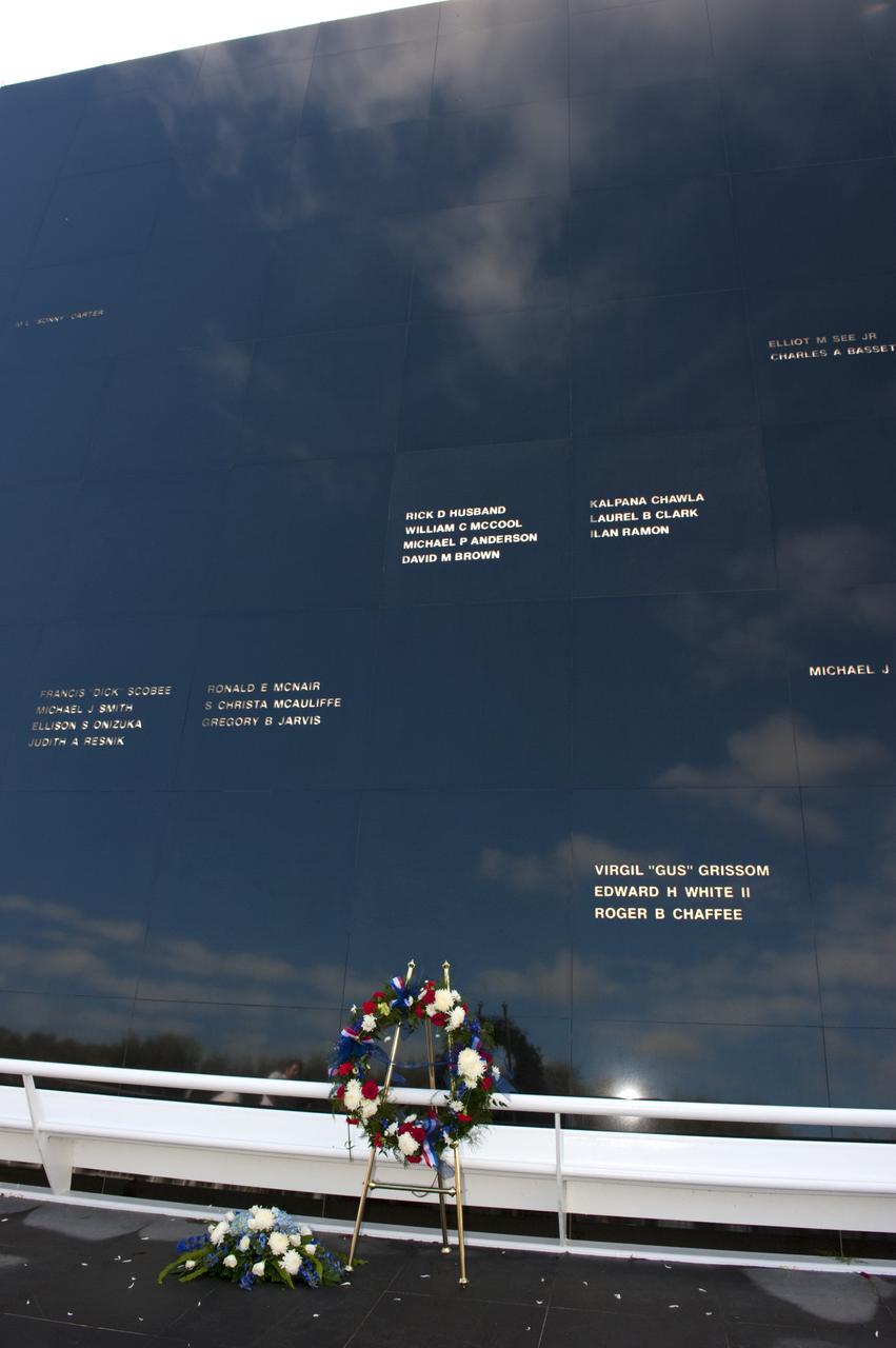 CAPE CANAVERAL, Fla. -- A blue sky is reflected in the massive granite Space Mirror Memorial at the Kennedy Space Center Visitor Complex in Florida where a large wreath was placed during Kennedy Space Center’s NASA Day of Remembrance.      The Day of Remembrance honors members of the NASA family who lost their lives while furthering the cause of exploration and discovery, including the astronaut crews of Apollo 1 and space shuttles Challenger and Columbia. Kennedy civil service and contractor employees, along with the general public, paid their respects throughout the day. The visitor complex provided flowers for visitors to place at the memorial. Photo credit: NASA/Kim Shiflett