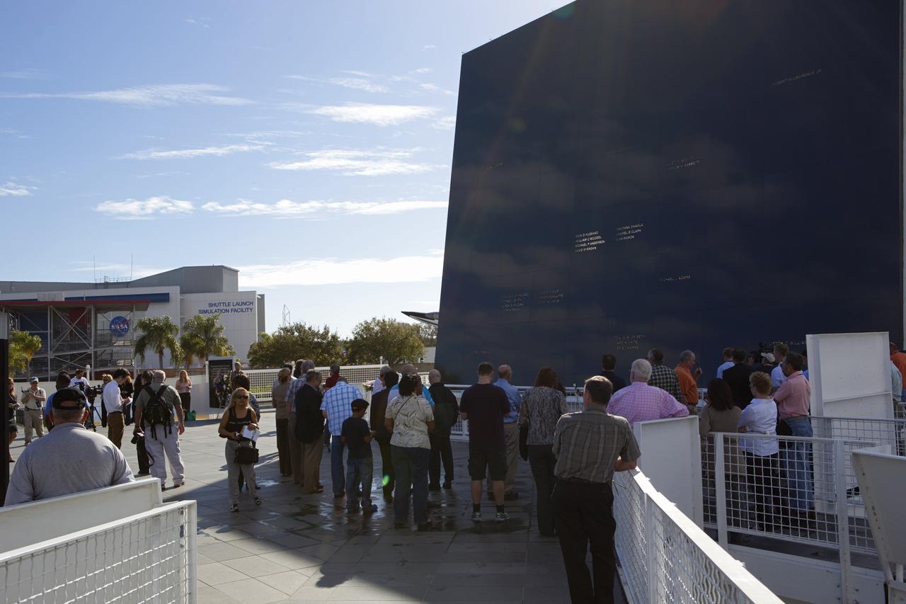 CAPE CANAVERAL, Fla. -- NASA Kennedy Space Center civil service and contractor workers, along with visitors gather at the Space Mirror Memorial at the Kennedy Space Center Visitor Complex in Florida for Kennedy Space Center’s NASA Day of Remembrance. Kennedy Center Director Robert Cabana, Deputy Director Janet Petro, and United Space Alliance’s Vice President for Aerospace Services/Florida Site Director Mark Nappi placed a wreath at the memorial. The Day of Remembrance honors members of the NASA family who lost their lives while furthering the cause of exploration and discovery, including the astronaut crews of Apollo 1 and space shuttles Challenger and Columbia. Kennedy civil service and contractor employees, along with the general public, paid their respects throughout the day. The visitor complex provided flowers for visitors to place at the memorial. Photo credit: NASA/Dimitri Gerondidakis