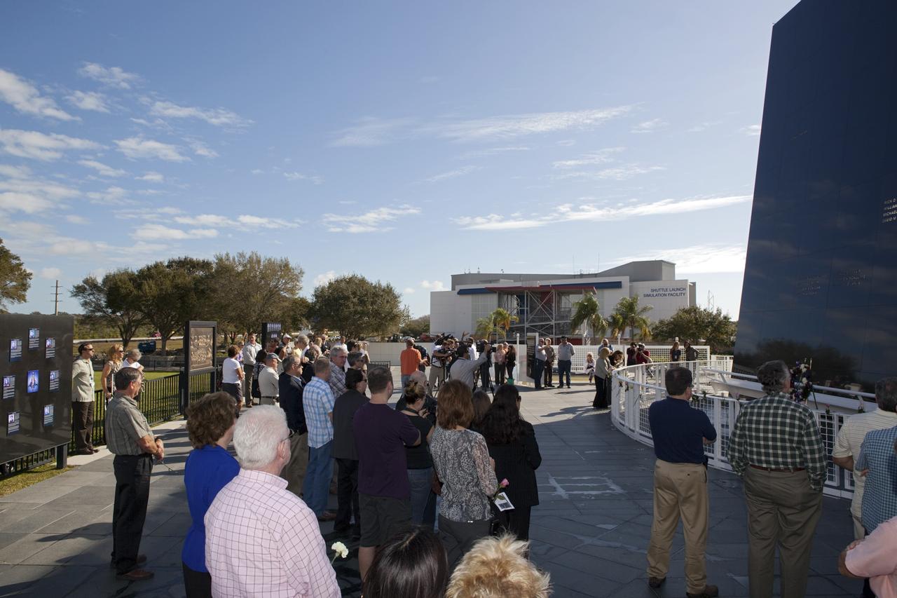 CAPE CANAVERAL, Fla. -- NASA Kennedy Space Center civil service and contractor workers, along with visitors gather at the Space Mirror Memorial at the Kennedy Space Center Visitor Complex in Florida for Kennedy Space Center’s NASA Day of Remembrance. Kennedy Center Director Robert Cabana, Deputy Director Janet Petro, and United Space Alliance’s Vice President for Aerospace Services/Florida Site Director Mark Nappi placed a wreath at the memorial. The Day of Remembrance honors members of the NASA family who lost their lives while furthering the cause of exploration and discovery, including the astronaut crews of Apollo 1 and space shuttles Challenger and Columbia. Kennedy civil service and contractor employees, along with the general public, paid their respects throughout the day. The visitor complex provided flowers for visitors to place at the memorial. Photo credit: NASA/Dimitri Gerondidakis