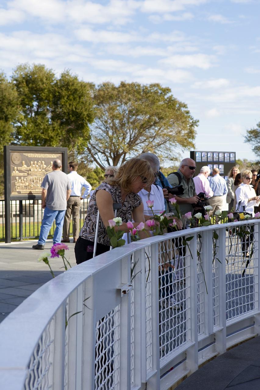 CAPE CANAVERAL, Fla. -- Visitors place roses at the Space Mirror Memorial at the Kennedy Space Center Visitor Complex in Florida during Kennedy Space Center’s NASA Day of Remembrance. Kennedy Center Director Robert Cabana, Deputy Director Janet Petro, and United Space Alliance’s Vice President for Aerospace Services/Florida Site Director Mark Nappi placed a wreath at the memorial. The Day of Remembrance honors members of the NASA family who lost their lives while furthering the cause of exploration and discovery, including the astronaut crews of Apollo 1 and space shuttles Challenger and Columbia. Kennedy civil service and contractor employees, along with the general public, paid their respects throughout the day. The visitor complex provided flowers for visitors to place at the memorial. Photo credit: NASA/Dimitri Gerondidakis
