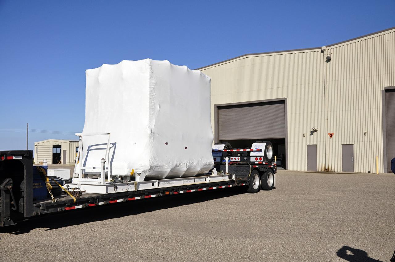 VANDENBERG AIR FORCE BASE, Calif. -- Preparations are under way at Vandenberg Air Force Base (VAFB) in California to transfer NASA's newly arrived Nuclear Spectroscopic Telescope Array (NuSTAR), enclosed in an environmentally controlled shipping container, into the airlock of processing facility 1555. The spacecraft arrived at 7:52 a.m. PST after a cross-country trip from Orbital Sciences' manufacturing plant in Dulles, Va., which began Jan. 24. The spacecraft will be offloaded into the processing hangar, joining the Pegasus XL rocket that is set to carry it to space. After NuSTAR is removed from its shipping container, checkout and other processing activity will begin. The spacecraft will be integrated with the Pegasus in mid-February and encapsulation in the vehicle fairing will follow. After processing is completed, the rocket and spacecraft will be flown on Orbital's L-1011 carrier aircraft to the Ronald Reagan Ballistic Missile Defense Test Site at the Pacific Ocean's Kwajalein Atoll for launch in March. The high-energy x-ray telescope will conduct a census for black holes, map radioactive material in young supernovae remnants, and study the origins of cosmic rays and the extreme physics around collapsed stars. For more information, visit http://www.nasa.gov/nustar. Photo credit: NASA/Randy Beaudoin, VAFB