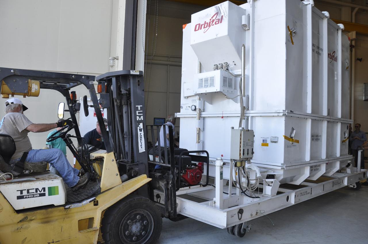 VANDENBERG AIR FORCE BASE, Calif. -- A forklift is enlisted to transfer the environmentally controlled shipping container enclosing NASA's Nuclear Spectroscopic Telescope Array (NuSTAR) from the airlock to the high bay of processing facility 1555 at Vandenberg Air Force Base (VAFB) in California. The spacecraft arrived at 7:52 a.m. PST after a cross-country trip from Orbital Sciences' manufacturing plant in Dulles, Va., which began Jan. 24. The spacecraft will be offloaded into the processing hangar, joining the Pegasus XL rocket that is set to carry it to space. After NuSTAR is removed from its shipping container, checkout and other processing activity will begin. The spacecraft will be integrated with the Pegasus in mid-February and encapsulation in the vehicle fairing will follow. After processing is completed, the rocket and spacecraft will be flown on Orbital's L-1011 carrier aircraft to the Ronald Reagan Ballistic Missile Defense Test Site at the Pacific Ocean's Kwajalein Atoll for launch in March. The high-energy x-ray telescope will conduct a census for black holes, map radioactive material in young supernovae remnants, and study the origins of cosmic rays and the extreme physics around collapsed stars. For more information, visit http://www.nasa.gov/nustar. Photo credit: NASA/Randy Beaudoin, VAFB
