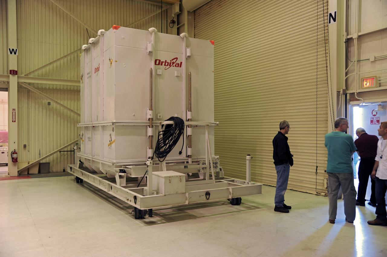 VANDENBERG AIR FORCE BASE, Calif. -- The payload transporter carrying the environmentally controlled shipping container enclosing NASA's Nuclear Spectroscopic Telescope Array (NuSTAR) is parked in the airlock of processing facility 1555 at Vandenberg Air Force Base (VAFB) in California. The spacecraft arrived at 7:52 a.m. PST after a cross-country trip which began Jan. 24 from Orbital Sciences' manufacturing plant in Dulles, Va. The spacecraft will be removed from the shipping container in the airlock and transferred into the processing hangar, joining the Pegasus XL rocket that is set to carry it to space. After checkout and other processing activities are complete, the spacecraft will be integrated with the Pegasus in mid-February and encapsulation in the vehicle fairing will follow. The rocket and spacecraft then will be flown on Orbital's L-1011 carrier aircraft to the Ronald Reagan Ballistic Missile Defense Test Site at the Pacific Ocean's Kwajalein Atoll for launch in March. The high-energy x-ray telescope will conduct a census for black holes, map radioactive material in young supernovae remnants, and study the origins of cosmic rays and the extreme physics around collapsed stars. For more information, visit http://www.nasa.gov/nustar. Photo credit: NASA/Randy Beaudoin, VAFB