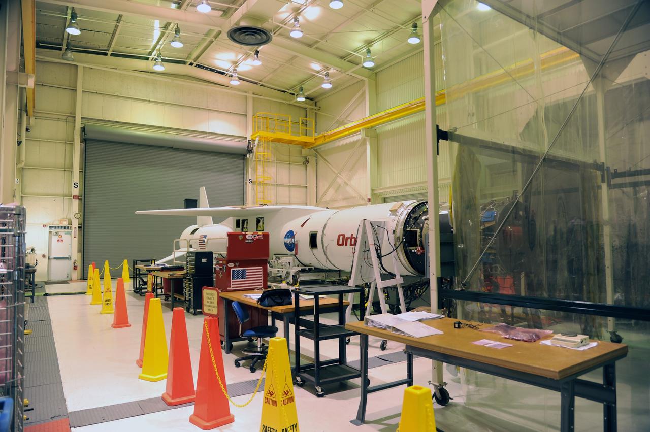 VANDENBERG AIR FORCE BASE, Calif. -- The Orbital Sciences Pegasus XL rocket that will carry NASA's Nuclear Spectroscopic Telescope Array (NuSTAR) into space awaits integration with the spacecraft in the clean room of processing facility 1555 at Vandenberg Air Force Base (VAFB) in California. The spacecraft arrived at 7:52 a.m. PST after a cross-country trip which began Jan. 24 from Orbital Sciences' manufacturing plant in Dulles, Va. The spacecraft will be removed from the shipping container in the airlock and transferred into the processing hangar, joining the Pegasus XL rocket that is set to carry it to space. After checkout and other processing activities are complete, the spacecraft will be integrated with the Pegasus in mid-February and encapsulation in the vehicle fairing will follow. The rocket and spacecraft then will be flown on Orbital's L-1011 carrier aircraft to the Ronald Reagan Ballistic Missile Defense Test Site at the Pacific Ocean's Kwajalein Atoll for launch in March. The high-energy x-ray telescope will conduct a census for black holes, map radioactive material in young supernovae remnants, and study the origins of cosmic rays and the extreme physics around collapsed stars. For more information, visit http://www.nasa.gov/nustar. Photo credit: NASA/Randy Beaudoin, VAFB