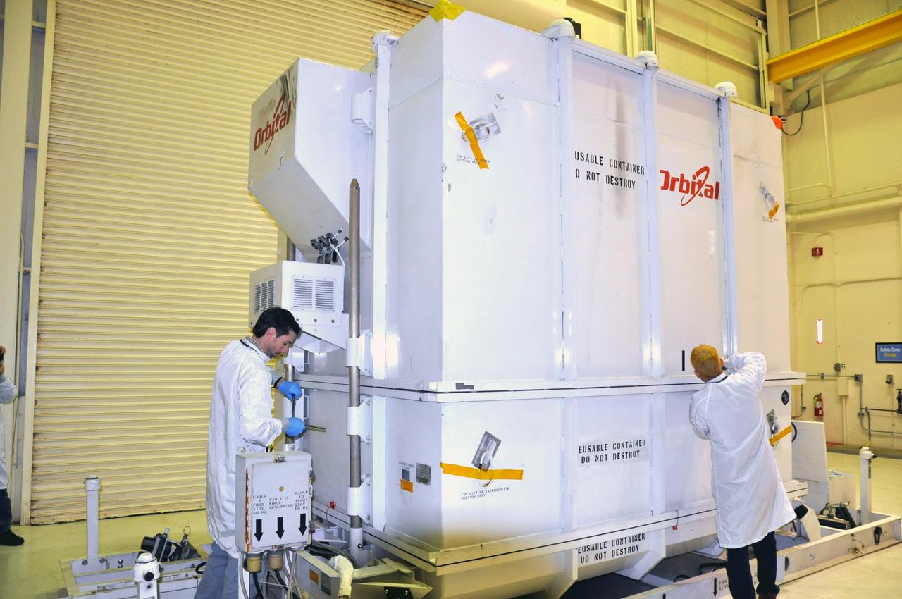 VANDENBERG AIR FORCE BASE, Calif. -- In the airlock of processing facility 1555 at Vandenberg Air Force Base (VAFB) in California, preparations are under way to remove the environmentally controlled shipping container from around NASA's Nuclear Spectroscopic Telescope Array (NuSTAR). The spacecraft arrived at VAFB Jan. 27 after a cross-country trip which began from Orbital Sciences' manufacturing plant in Dulles, Va., on Jan. 24. Next, NuSTAR will be transferred from the airlock into the processing hangar, joining the Pegasus XL rocket that is set to carry it to space. After checkout and other processing activities are complete, the spacecraft will be integrated with the Pegasus in mid-February and encapsulation in the vehicle fairing will follow. The rocket and spacecraft then will be flown on Orbital's L-1011 carrier aircraft to the Ronald Reagan Ballistic Missile Defense Test Site at the Pacific Ocean's Kwajalein Atoll for launch in March. The high-energy X-ray telescope will conduct a census for black holes, map radioactive material in young supernovae remnants, and study the origins of cosmic rays and the extreme physics around collapsed stars. For more information, visit http://www.nasa.gov/nustar. Photo credit: NASA/Randy Beaudoin, VAFB