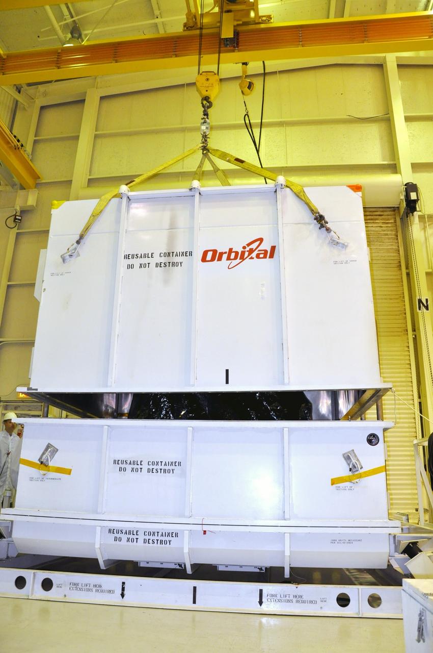 VANDENBERG AIR FORCE BASE, Calif. -- In the airlock of processing facility 1555 at Vandenberg Air Force Base (VAFB) in California, a crane lifts half of the environmentally controlled shipping container, providing a glimpse of NASA's Nuclear Spectroscopic Telescope Array (NuSTAR).    The spacecraft arrived at VAFB Jan. 27 after a cross-country trip which began from Orbital Sciences' manufacturing plant in Dulles, Va., on Jan. 24. Next, NuSTAR will be transferred from the airlock into the processing hangar, joining the Pegasus XL rocket that is set to carry it to space. After checkout and other processing activities are complete, the spacecraft will be integrated with the Pegasus in mid-February and encapsulation in the vehicle fairing will follow. The rocket and spacecraft then will be flown on Orbital's L-1011 carrier aircraft to the Ronald Reagan Ballistic Missile Defense Test Site at the Pacific Ocean's Kwajalein Atoll for launch in March.  The high-energy X-ray telescope will conduct a census for black holes, map radioactive material in young supernovae remnants, and study the origins of cosmic rays and the extreme physics around collapsed stars. For more information, visit http://www.nasa.gov/nustar. Photo credit: NASA/Randy Beaudoin, VAFB