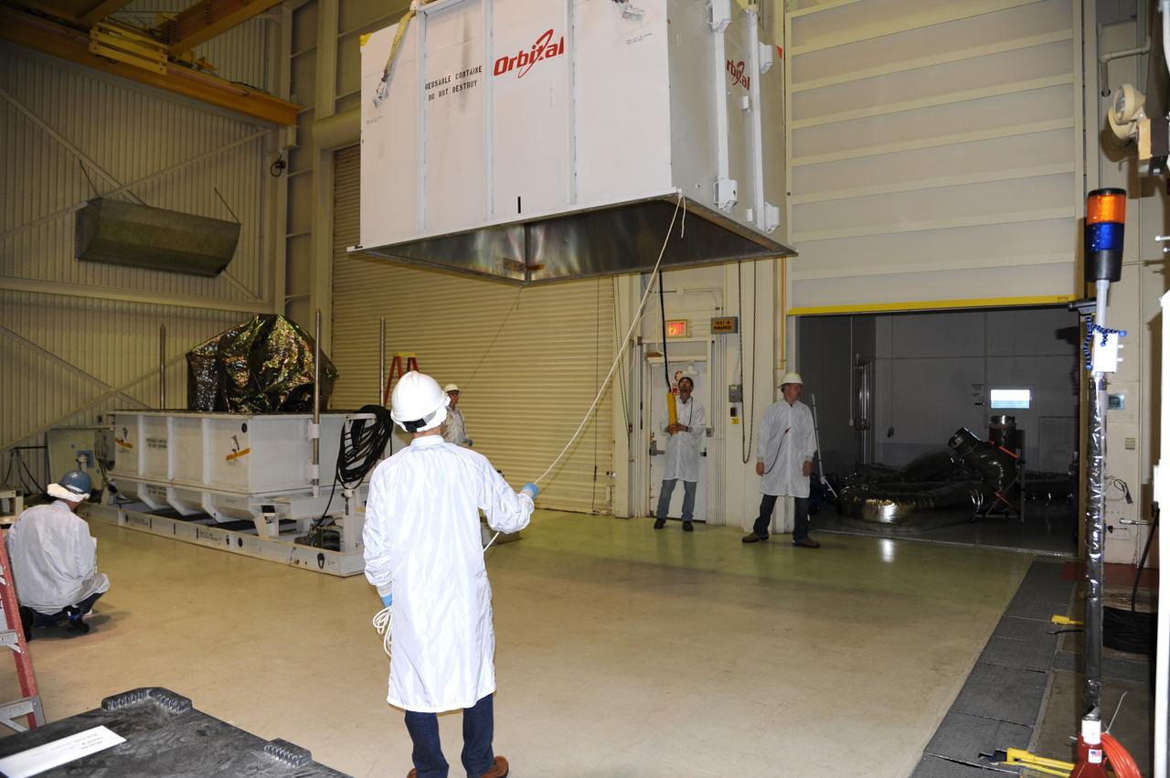 VANDENBERG AIR FORCE BASE, Calif. -- In the airlock of processing facility 1555 at Vandenberg Air Force Base (VAFB) in California, the top half of the shipping container is lifted away from NASA's Nuclear Spectroscopic Telescope Array (NuSTAR), wrapped in a protective shroud. The spacecraft arrived at VAFB Jan. 27 after a cross-country trip which began from Orbital Sciences' manufacturing plant in Dulles, Va., on Jan. 24. Next, NuSTAR will be transferred from the airlock into the processing hangar, joining the Pegasus XL rocket that is set to carry it to space. After checkout and other processing activities are complete, the spacecraft will be integrated with the Pegasus in mid-February and encapsulation in the vehicle fairing will follow. The rocket and spacecraft then will be flown on Orbital's L-1011 carrier aircraft to the Ronald Reagan Ballistic Missile Defense Test Site at the Pacific Ocean's Kwajalein Atoll for launch in March. The high-energy X-ray telescope will conduct a census for black holes, map radioactive material in young supernovae remnants, and study the origins of cosmic rays and the extreme physics around collapsed stars. For more information, visit http://www.nasa.gov/nustar. Photo credit: NASA/Randy Beaudoin, VAFB