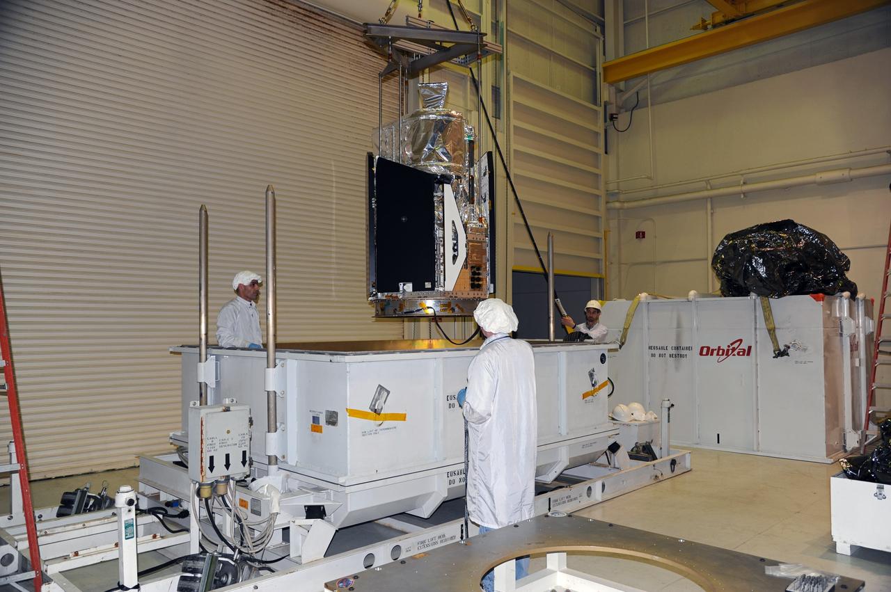 VANDENBERG AIR FORCE BASE, Calif. -- In the airlock of processing facility 1555 at Vandenberg Air Force Base (VAFB) in California, NASA's Nuclear Spectroscopic Telescope Array (NuSTAR) hovers above its shipping container during transfer to a handling dolly. The spacecraft arrived at VAFB Jan. 27 after a cross-country trip which began from Orbital Sciences' manufacturing plant in Dulles, Va., on Jan. 24. Next, NuSTAR will be transferred from the airlock into the processing hangar, joining the Pegasus XL rocket that is set to carry it to space. After checkout and other processing activities are complete, the spacecraft will be integrated with the Pegasus in mid-February and encapsulation in the vehicle fairing will follow. The rocket and spacecraft then will be flown on Orbital's L-1011 carrier aircraft to the Ronald Reagan Ballistic Missile Defense Test Site at the Pacific Ocean's Kwajalein Atoll for launch in March. The high-energy X-ray telescope will conduct a census for black holes, map radioactive material in young supernovae remnants, and study the origins of cosmic rays and the extreme physics around collapsed stars. For more information, visit http://www.nasa.gov/nustar. Photo credit: NASA/Randy Beaudoin, VAFB
