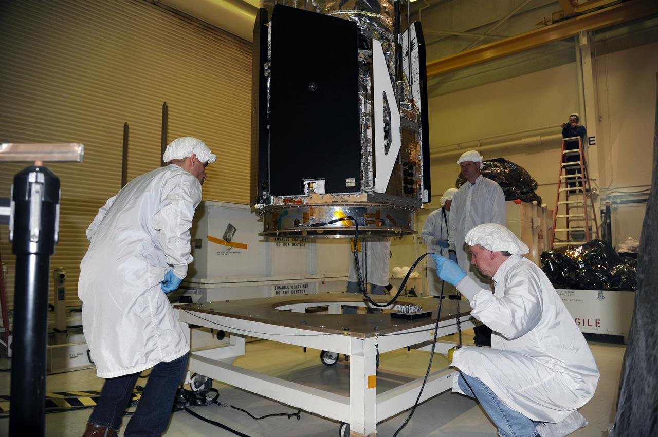 VANDENBERG AIR FORCE BASE, Calif. -- In the airlock of processing facility 1555 at Vandenberg Air Force Base (VAFB) in California, workers monitor NASA's Nuclear Spectroscopic Telescope Array (NuSTAR) as it is lowered onto a handling dolly. The spacecraft arrived at VAFB Jan. 27 after a cross-country trip which began from Orbital Sciences' manufacturing plant in Dulles, Va., on Jan. 24. Next, NuSTAR will be transferred from the airlock into the processing hangar, joining the Pegasus XL rocket that is set to carry it to space. After checkout and other processing activities are complete, the spacecraft will be integrated with the Pegasus in mid-February and encapsulation in the vehicle fairing will follow. The rocket and spacecraft then will be flown on Orbital's L-1011 carrier aircraft to the Ronald Reagan Ballistic Missile Defense Test Site at the Pacific Ocean's Kwajalein Atoll for launch in March. The high-energy X-ray telescope will conduct a census for black holes, map radioactive material in young supernovae remnants, and study the origins of cosmic rays and the extreme physics around collapsed stars. For more information, visit http://www.nasa.gov/nustar. Photo credit: NASA/Randy Beaudoin, VAFB