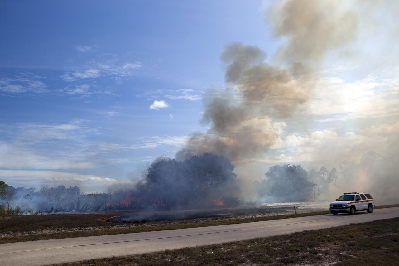 CAPE CANAVERAL, Fla. -- A controlled burn in the vicinity of the Industrial Area at NASA's Kennedy Space Center in Florida sends billow of smoke over nearby roadways.    The burn, managed by the U.S. Fish and Wildlife Service, targeted 2,174 acres near Kennedy's administrative complex. Shifting winds caused the fire to flare up in places to dramatic effect. Limited visibility caused by the smoke required NASA Security to close some roadways. The burn, which began during the 8 o'clock hour this morning, is expected to be extinguished this evening. Controlled burns are commonplace on the center to reduce the likelihood of an unplanned brush fire during Central Florida's dry season. Photo Credit: NASA/Dimitri Gerondidakis