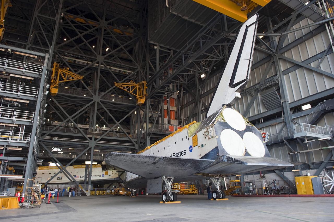CAPE CANAVERAL, Fla. – Inside the Vehicle Assembly Building at NASA’s Kennedy Space Center in Florida, space shuttle Endeavour is being prepared to be backed out and towed to Orbiter Processing Facility-2 (OPF-2). In the background is space shuttle Atlantis.     Shuttle Endeavour will remain in OPF-2 so that the orbiter maneuvering system (OMS) pods and forward reaction control system can be installed. Technicians also will offload water and Freon gas from lines located in Endeavour’s midbody. The work is part of Endeavour’s transition and retirement processing. The spacecraft is being prepared for public display at the California Science Center in Los Angeles. Endeavour flew 25 missions, spent 299 days in space, orbited Earth 4,671 times and traveled 122, 883, 151 miles over the course of its 19-year career. Endeavour’s STS-134 and final mission was completed after landing on June 1, 2011. Photo credit: Kim Shiflett