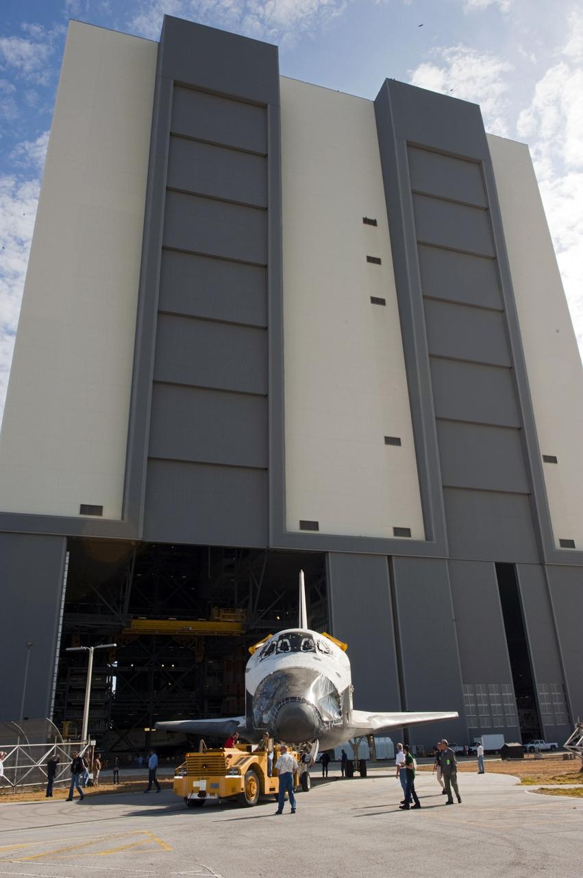 CAPE CANAVERAL, Fla. – With the massive doors of the Vehicle Assembly Building at NASA’s Kennedy Space Center in Florida in the background, space shuttle Endeavour is being towed from the VAB to Orbiter Processing Facility-2. Shuttle Endeavour will remain in OPF-2 so that the orbiter maneuvering system (OMS) pods and forward reaction control system can be installed. Technicians also will offload water and Freon gas from lines located in Endeavour’s midbody. The work is part of Endeavour’s transition and retirement processing. The spacecraft is being prepared for public display at the California Science Center in Los Angeles. Endeavour flew 25 missions, spent 299 days in space, orbited Earth 4,671 times and traveled 122, 883, 151 miles over the course of its 19-year career. Endeavour’s STS-134 and final mission was completed after landing on June 1, 2011. Photo credit: Kim Shiflett