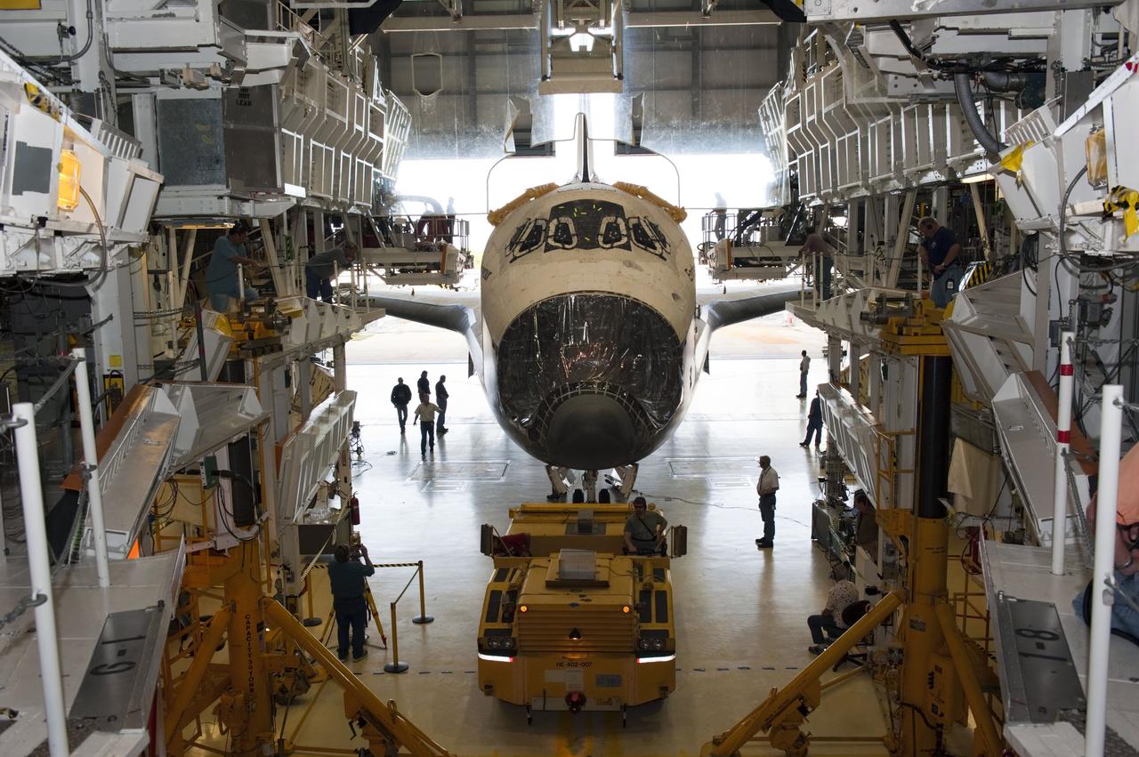 CAPE CANAVERAL, Fla. – At NASA’s Kennedy Space Center in Florida, space shuttle Endeavour is towed inside Orbiter Processing Facility-2 (OPF-2). Shuttle Endeavour will remain in OPF-2 so that the orbiter maneuvering system (OMS) pods and forward reaction control system can be installed. Technicians also will offload water and Freon gas from lines located in Endeavour’s midbody. The work is part of Endeavour’s transition and retirement processing. The spacecraft is being prepared for public display at the California Science Center in Los Angeles. Endeavour flew 25 missions, spent 299 days in space, orbited Earth 4,671 times and traveled 122, 883, 151 miles over the course of its 19-year career. Endeavour’s STS-134 and final mission was completed after landing on June 1, 2011. Photo credit: Kim Shiflett