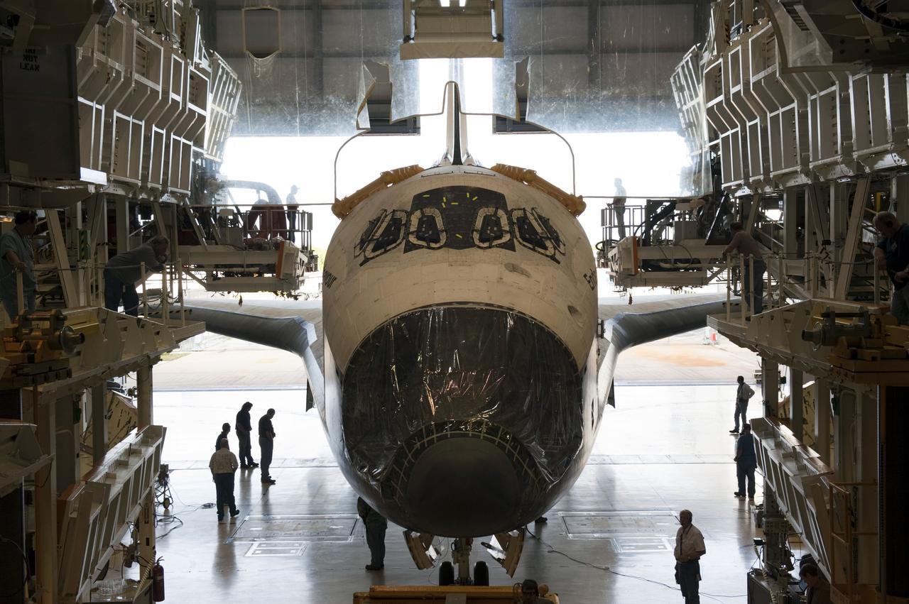CAPE CANAVERAL, Fla. – At NASA’s Kennedy Space Center in Florida, space shuttle Endeavour is towed inside Orbiter Processing Facility-2 (OPF-2). Shuttle Endeavour will remain in OPF-2 so that the orbiter maneuvering system (OMS) pods and forward reaction control system can be installed. Technicians also will offload water and Freon gas from lines located in Endeavour’s midbody. The work is part of Endeavour’s transition and retirement processing. The spacecraft is being prepared for public display at the California Science Center in Los Angeles. Endeavour flew 25 missions, spent 299 days in space, orbited Earth 4,671 times and traveled 122, 883, 151 miles over the course of its 19-year career. Endeavour’s STS-134 and final mission was completed after landing on June 1, 2011. Photo credit: Kim Shiflett