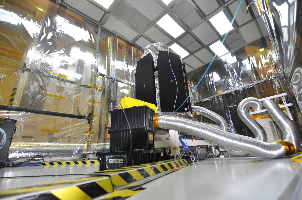 VANDENBERG AIR FORCE BASE, Calif. -- In a clean room at Vandenberg Air Force Base's processing facility in California, NASA's NuSTAR spacecraft undergoes a limited performance test, a two-day functional checkout of the spacecraft. A Pegasus XL rocket is set to launch NuSTAR into space. Once the rocket and spacecraft are processed at Vandenberg, they will be flown on the Orbital Sciences’ L-1011 carrier aircraft to the Ronald Reagan Ballistic Missile Defense Test Site at the Pacific Ocean’s Kwajalein Atoll for launch. The high-energy x-ray telescope will conduct a census for black holes, map radioactive material in young supernovae remnants, and study the origins of cosmic rays and the extreme physics around collapsed stars. For more information, visit science.nasa.gov/missions/nustar/. Photo credit: NASA/Randy Beaudoin, VAFB