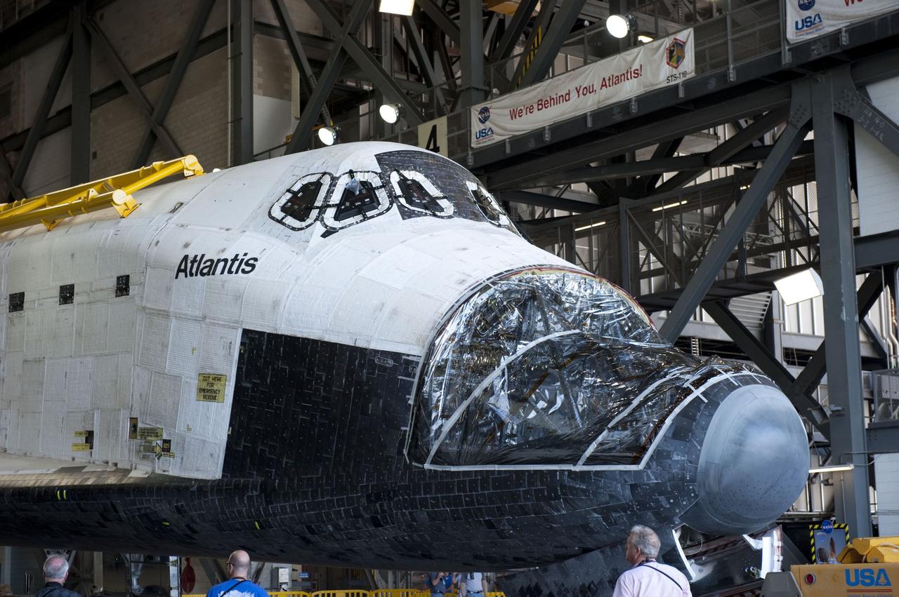 CAPE CANAVERAL, Fla. – Inside the Vehicle Assembly Building (VAB) at NASA’s Kennedy Space Center in Florida, technicians prepare space shuttle Atlantis to be towed out of the transfer aisle and around to the VAB high bay 4 doors.      Shuttle Atlantis will remain in temporary storage in high bay 4, while Space Shuttle Program transition and retirement work continues on Discovery and Endeavour in the orbiter processing facilities. Atlantis is being prepared for display at the Kennedy Space Center Visitor Complex.  Photo credit: NASA/Kim Shiflett