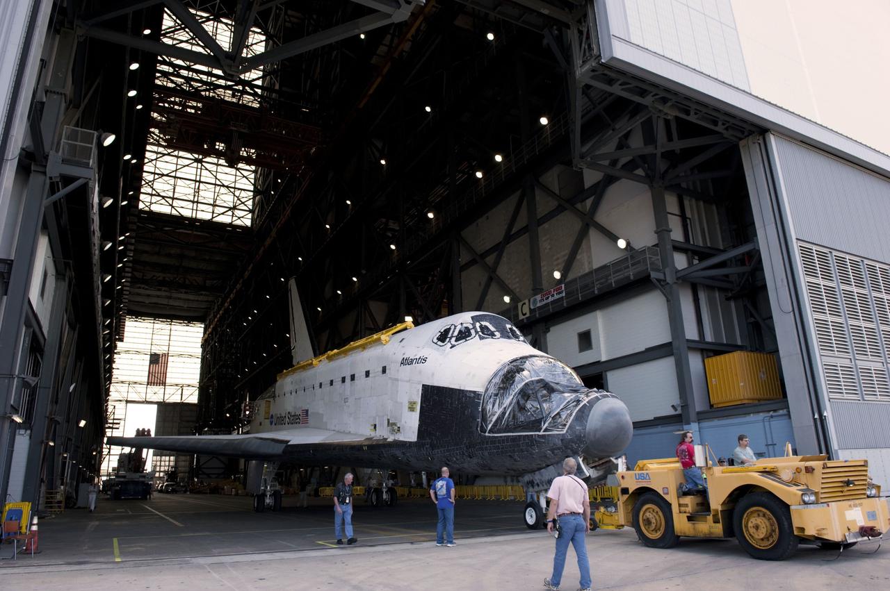 CAPE CANAVERAL, Fla. – Inside the Vehicle Assembly Building (VAB) at NASA’s Kennedy Space Center in Florida, technicians begin to tow space shuttle Atlantis out of the transfer aisle and around to the VAB high bay 4 doors.     Shuttle Atlantis will remain in temporary storage in high bay 4, while Space Shuttle Program transition and retirement work continues on Discovery and Endeavour in the orbiter processing facilities. Atlantis is being prepared for display at the Kennedy Space Center Visitor Complex.  Photo credit: NASA/Kim Shiflett