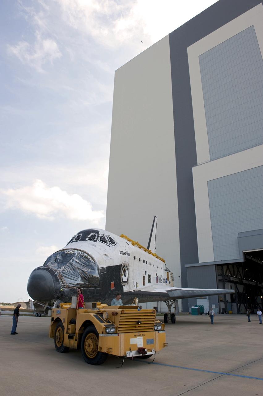 CAPE CANAVERAL, Fla. – At NASA’s Kennedy Space Center in Florida, space shuttle Atlantis is towed out of the Vehicle Assembly Building (VAB) transfer aisle and around to the VAB high bay 4 doors.    Shuttle Atlantis will remain in temporary storage in high bay 4, while Space Shuttle Program transition and retirement work continues on Discovery and Endeavour in the orbiter processing facilities. Atlantis is being prepared for display at the Kennedy Space Center Visitor Complex.  Photo credit: NASA/Kim Shiflett