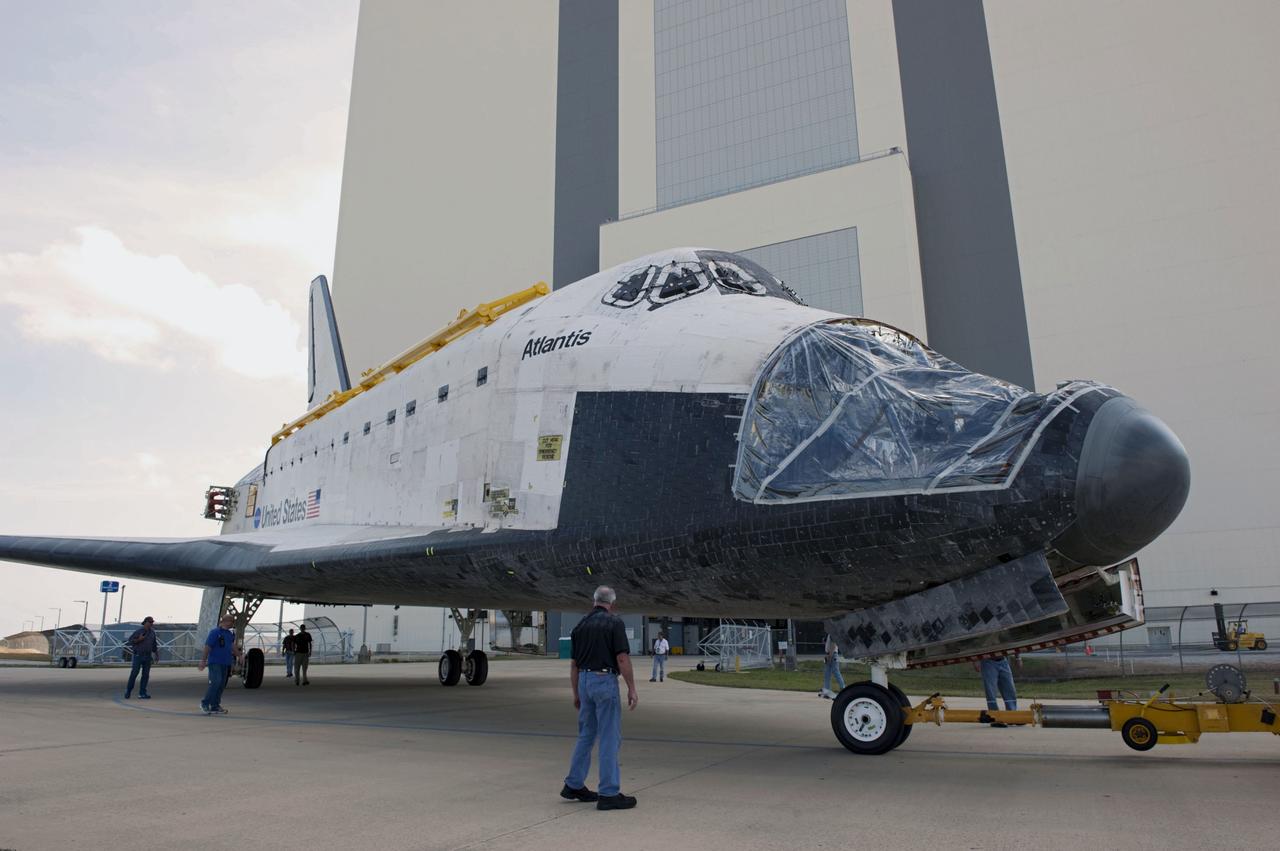 CAPE CANAVERAL, Fla. – At NASA’s Kennedy Space Center in Florida, technicians monitor the progress as space shuttle Atlantis is towed out of the Vehicle Assembly Building (VAB) transfer aisle and around to the VAB high bay 4 doors.    Shuttle Atlantis will remain in temporary storage in high bay 4, while Space Shuttle Program transition and retirement work continues on Discovery and Endeavour in the orbiter processing facilities. Atlantis is being prepared for display at the Kennedy Space Center Visitor Complex.  Photo credit: NASA/Kim Shiflett
