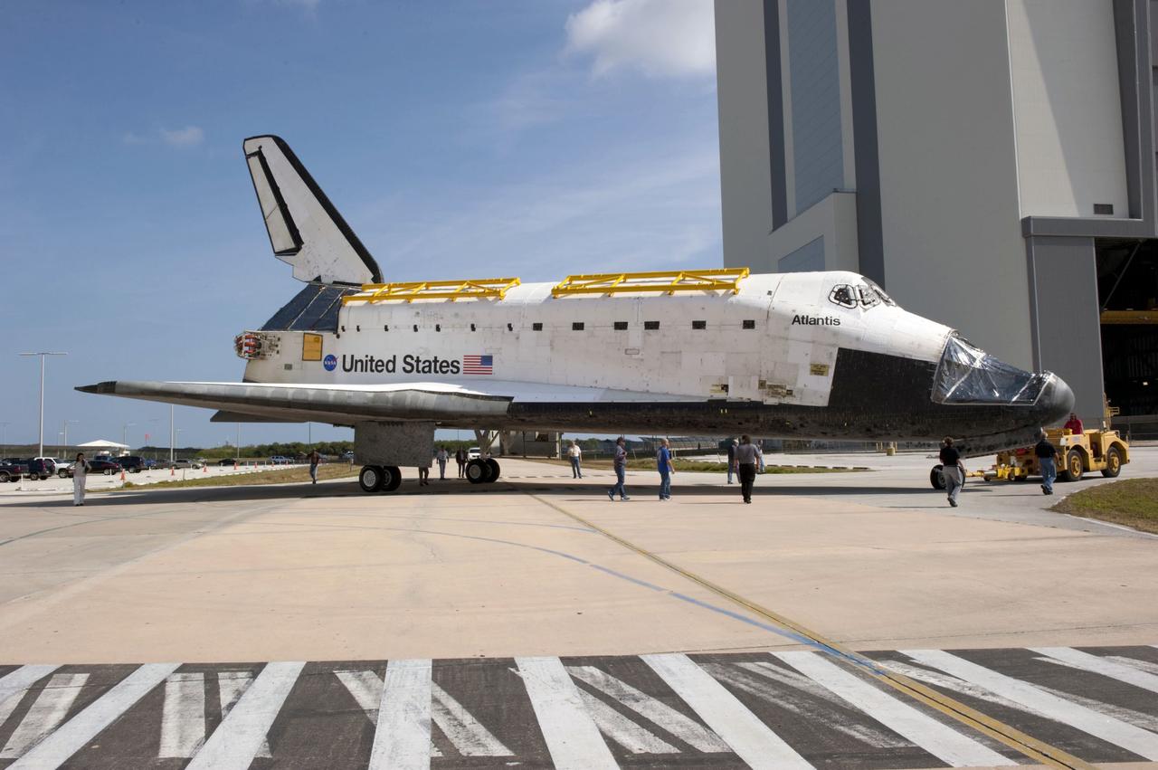 CAPE CANAVERAL, Fla. – At NASA’s Kennedy Space Center in Florida, space shuttle Atlantis is towed around toward the Vehicle Assembly Building (VAB) high bay 4 doors from the VAB transfer aisle.    Shuttle Atlantis will remain in temporary storage in high bay 4, while Space Shuttle Program transition and retirement work continues on Discovery and Endeavour in the orbiter processing facilities. Atlantis is being prepared for display at the Kennedy Space Center Visitor Complex.  Photo credit: NASA/Kim Shiflett