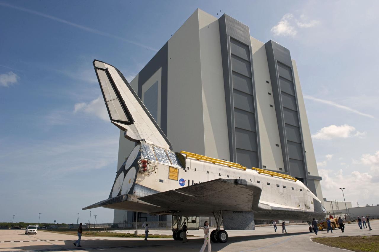 CAPE CANAVERAL, Fla. – At NASA’s Kennedy Space Center in Florida, space shuttle Atlantis is towed around toward the Vehicle Assembly Building (VAB) high bay 4 doors from the VAB transfer aisle.    Shuttle Atlantis will remain in temporary storage in high bay 4, while Space Shuttle Program transition and retirement work continues on Discovery and Endeavour in the orbiter processing facilities. Atlantis is being prepared for display at the Kennedy Space Center Visitor Complex.  Photo credit: NASA/Kim Shiflett