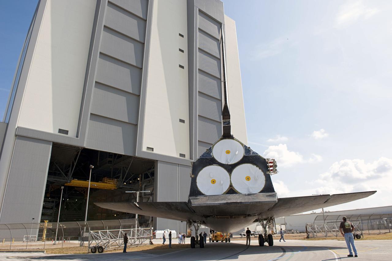CAPE CANAVERAL, Fla. – At NASA’s Kennedy Space Center in Florida, space shuttle Atlantis is towed toward the Vehicle Assembly Building (VAB) high bay 4 doors after being towed around from the VAB transfer aisle.    Shuttle Atlantis will remain in temporary storage in high bay 4, while Space Shuttle Program transition and retirement work continues on Discovery and Endeavour in the orbiter processing facilities. Atlantis is being prepared for display at the Kennedy Space Center Visitor Complex.  Photo credit: NASA/Kim Shiflett