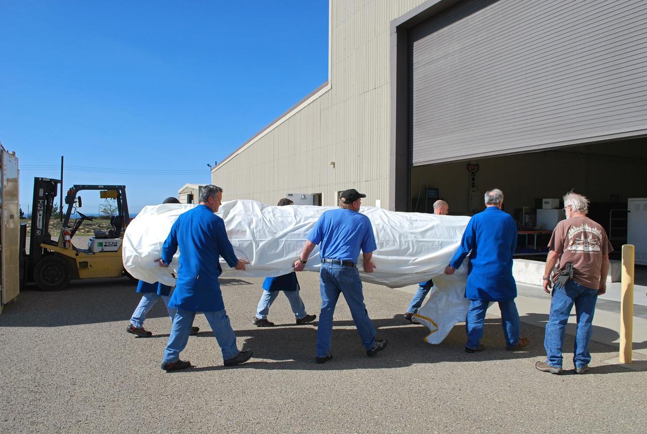 VANDENBERG AIR FORCE BASE, Calif. -- Workers unload the two halves that make up the Pegasus XL rocket's fairing that will protect the NuSTAR spacecraft during launch. Inside Orbital Science's processing facility, the fairing halves will be unwrapped and processed in a clean room environmental enclosure.       The Pegasus is set to launch NASA's NuSTAR spacecraft. Once the rocket and spacecraft are processed at Vandenberg, they will be flown on the Orbital Sciences’ L-1011 carrier aircraft to the Ronald Reagan Ballistic Missile Defense Test Site at the Pacific Ocean’s Kwajalein Atoll for launch. The high-energy x-ray telescope will conduct a census for black holes, map radioactive material in young supernovae remnants, and study the origins of cosmic rays and the extreme physics around collapsed stars. For more information, visit science.nasa.gov/missions/nustar/. Photo credit: NASA/Randy Beaudoin, VAFB