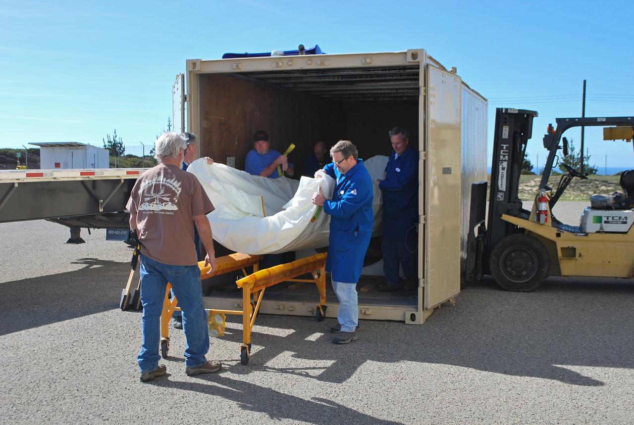 VANDENBERG AIR FORCE BASE, Calif. -- Workers unload the two halves that make up the Pegasus XL rocket's fairing that will protect the NuSTAR spacecraft during launch. Inside Orbital Science's processing facility, the fairing halves will be unwrapped and processed in a clean room environmental enclosure.       The Pegasus is set to launch NASA's NuSTAR spacecraft. Once the rocket and spacecraft are processed at Vandenberg, they will be flown on the Orbital Sciences’ L-1011 carrier aircraft to the Ronald Reagan Ballistic Missile Defense Test Site at the Pacific Ocean’s Kwajalein Atoll for launch. The high-energy x-ray telescope will conduct a census for black holes, map radioactive material in young supernovae remnants, and study the origins of cosmic rays and the extreme physics around collapsed stars. For more information, visit science.nasa.gov/missions/nustar/. Photo credit: NASA/Randy Beaudoin, VAFB