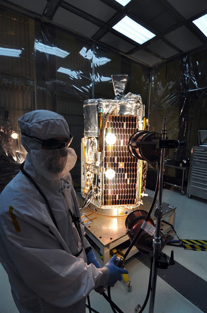 VANDENBERG AIR FORCE BASE, Calif. -- In a clean room at Vandenberg Air Force Base's processing facility in California, a technician conducts a solar array illumination test on NASA's NuSTAR spacecraft. A Pegasus XL rocket is set to launch NuSTAR into space. Once the rocket and spacecraft are processed at Vandenberg, they will be flown on the Orbital Sciences’ L-1011 carrier aircraft to the Ronald Reagan Ballistic Missile Defense Test Site at the Pacific Ocean’s Kwajalein Atoll for launch. The high-energy x-ray telescope will conduct a census for black holes, map radioactive material in young supernovae remnants, and study the origins of cosmic rays and the extreme physics around collapsed stars. For more information, visit science.nasa.gov/missions/nustar/. Photo credit: NASA/Randy Beaudoin, VAFB