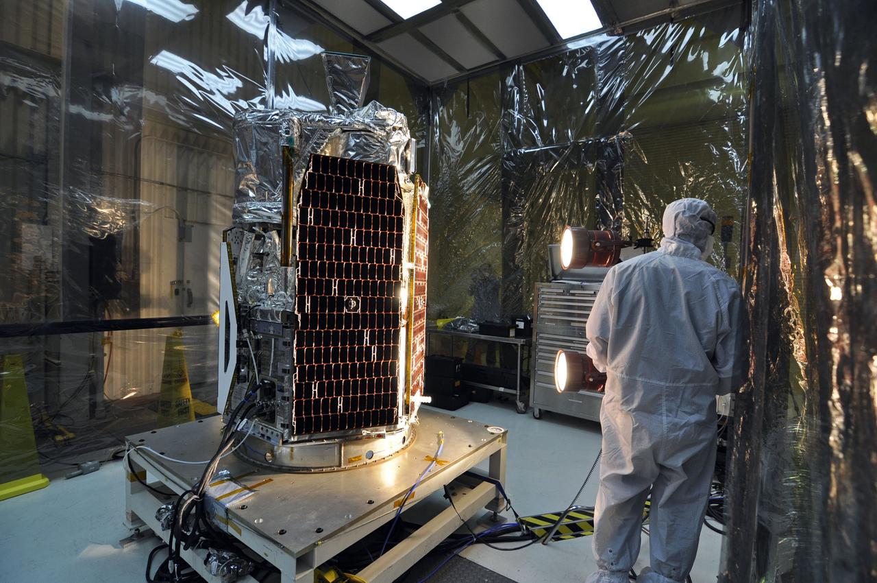 VANDENBERG AIR FORCE BASE, Calif. -- In a clean room at Vandenberg Air Force Base's processing facility in California, a technician conducts a solar array illumination test on NASA's NuSTAR spacecraft. A Pegasus XL rocket is set to launch NuSTAR into space. Once the rocket and spacecraft are processed at Vandenberg, they will be flown on the Orbital Sciences’ L-1011 carrier aircraft to the Ronald Reagan Ballistic Missile Defense Test Site at the Pacific Ocean’s Kwajalein Atoll for launch. The high-energy x-ray telescope will conduct a census for black holes, map radioactive material in young supernovae remnants, and study the origins of cosmic rays and the extreme physics around collapsed stars. For more information, visit science.nasa.gov/missions/nustar/. Photo credit: NASA/Randy Beaudoin, VAFB